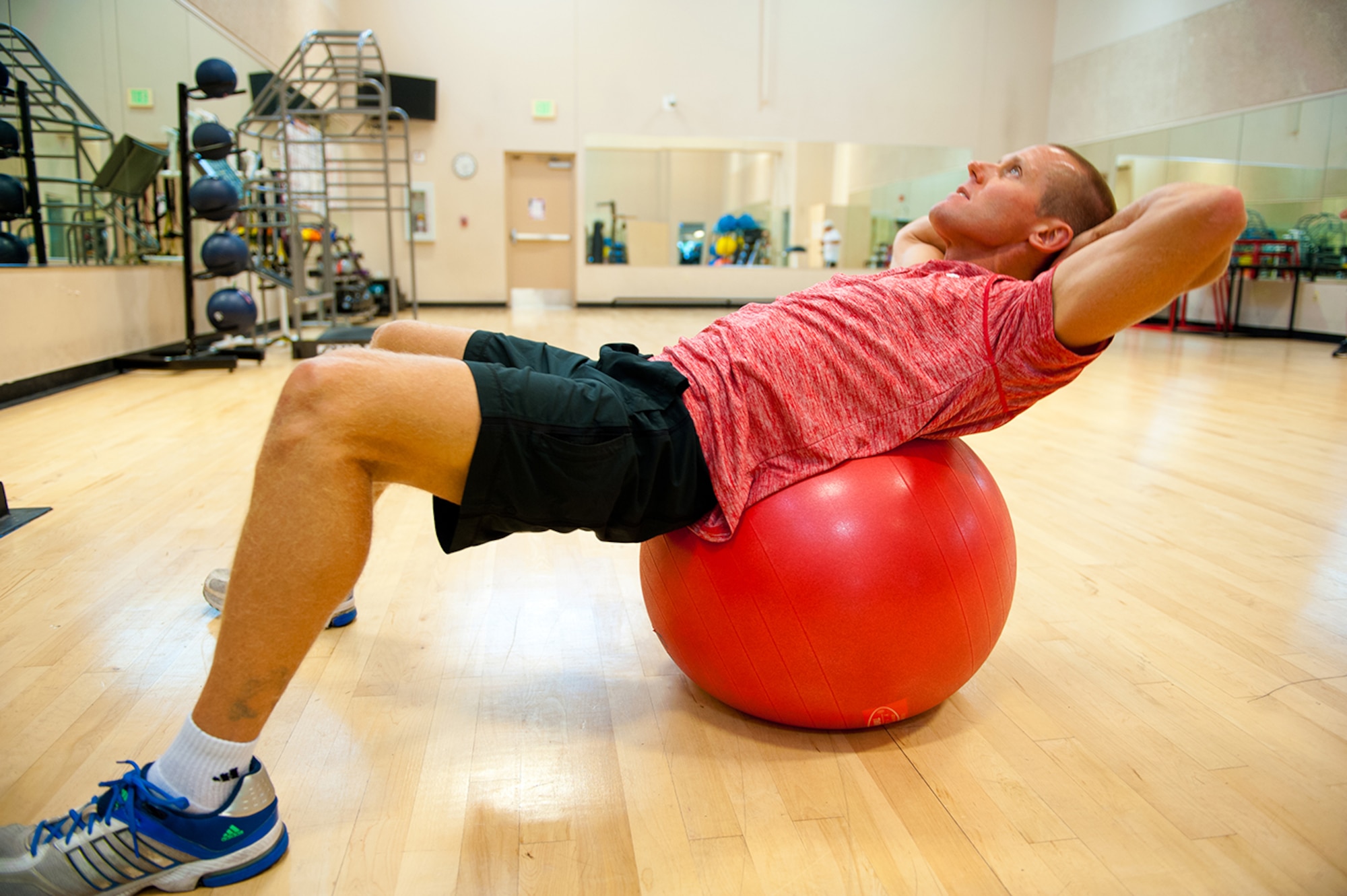 U.S. Air Force Lt. Col. Stephen Frank, instructor pilot, 559 Flying Training Squadron, uses a Swiss ball with his crunches, 16 July, 2014, Joint Base San Antonio-Randolph, Texas. (U.S. Air Force photo by Tech. Sgt. Sarayuth Pinthong/ Released)