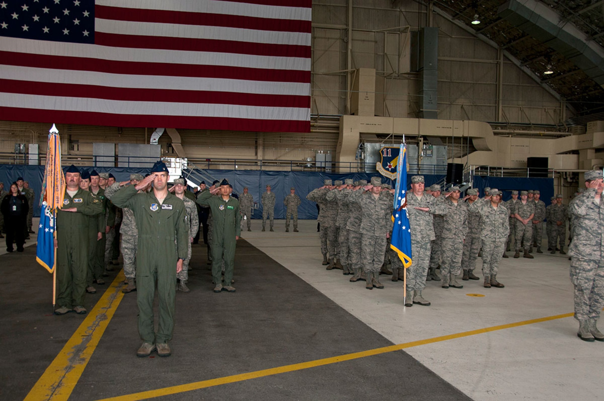 Airmen from the 3d Wing render Air Force Brig. Gen. David Nahom a final salute during the 3rd Wing change of command on JBER, Aug. 26. Nahom relinquished command of the 3rd Wing to Air Force Col. Charles Corcoran.  (U.S. Air Force photo/Airman 1st Class Tammie Ramsouer)