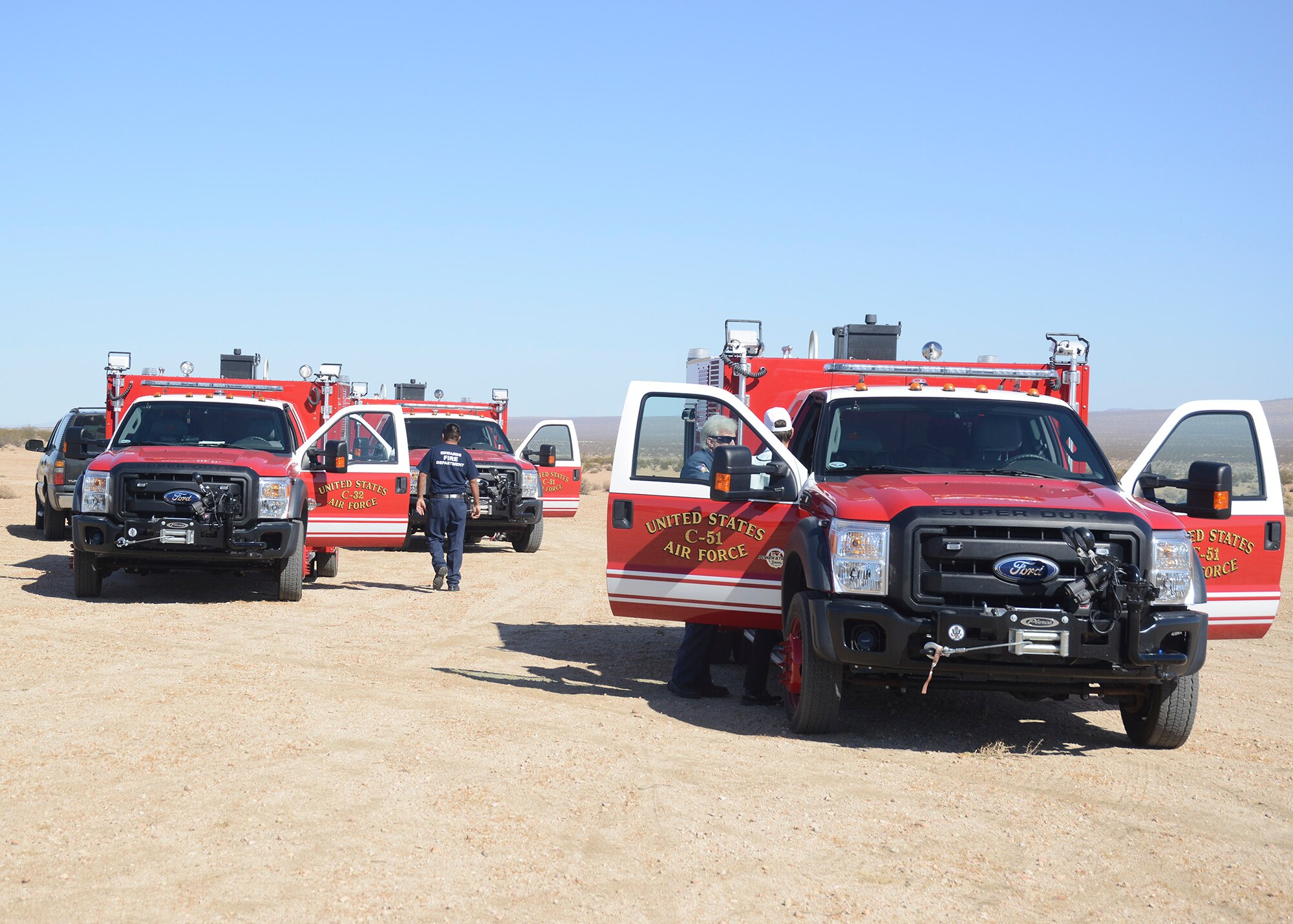 Edwards AFB Fire Department trucks arrive on the scene of the simulated crash site after being contacted by California City Police and Fire departments. (U.S. Air Force photo by Kenji Thuloweit) 