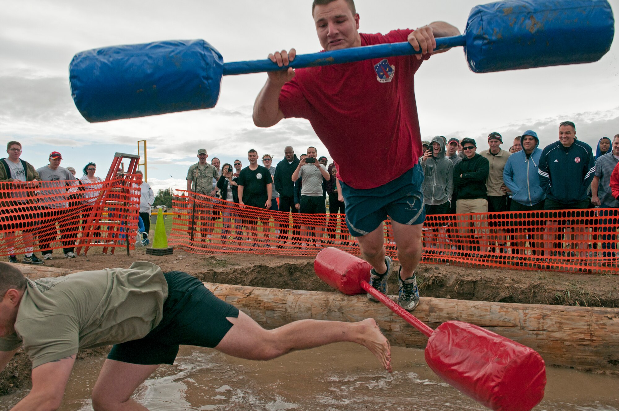 Airman 1st Class Daniel Davitt, 90th Medical Operations Squadron, falls from a log during a jousting match at Frontiercade on F.E. Warren Air Force Base, Wyo., Aug. 28, 2014. Frontiercade is an event held yearly on base to promote friendly competition amongst the units of 90th Missile Wing.(U.S. Air Force photo by Lan Kim)