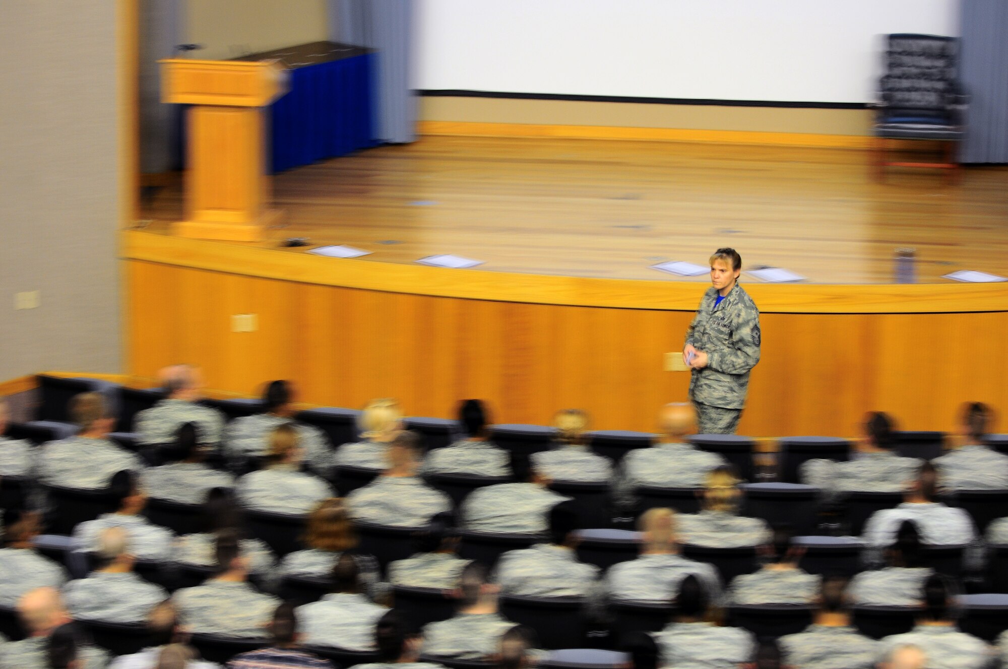 Chief Master Sgt. Teresa Clapper, 47th Flying Training Wing command chief, speaks to Airmen in Anderson Hall on Laughlin Air Force Base, Texas, Aug. 29, 2014. Since her arrival in June, Clapper has aggressively sought to connect with the members of Team XL and their families, through mediums like all calls, in an effort to establish expectations, build rapport among the wing and emphasis the importance of priorities. (U.S. Air Force photo by Staff Sgt. Steven R. Doty)(Released)