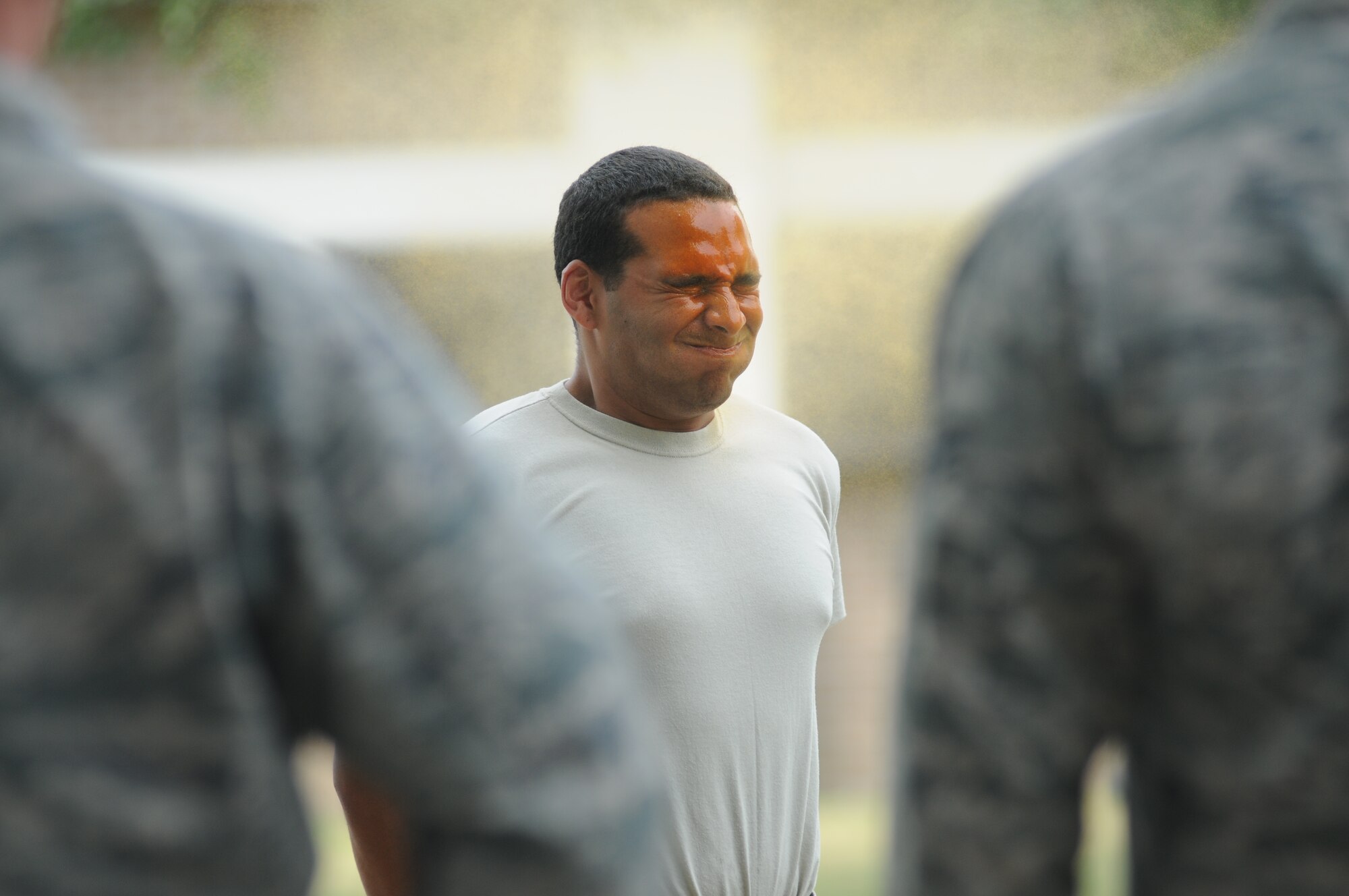 Airman 1st Class Nicholas Weller, 81st Security Forces Squadron augmentee, receives a spray of oleoresin capsaicin during OC spray training Aug. 28, 2014, at Keesler Air Force Base, Miss.  The training is a required one-time exposure of the OC spray for all Security Forces members.  (U.S. Air Force photo by Kemberly Groue)