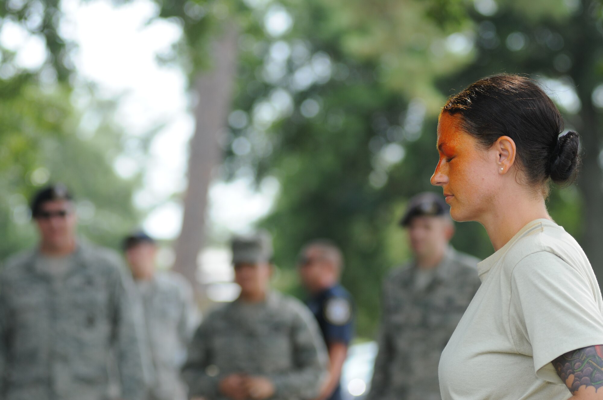 Staff Sgt. Eva Williams, 81st Security Forces Squadron augmentee, receives a spray of oleoresin capsaicin during OC spray training Aug. 28, 2014, at Keesler Air Force Base, Miss.  The training is a required one-time exposure of the OC spray for all Security Forces members.  (U.S. Air Force photo by Kemberly Groue)