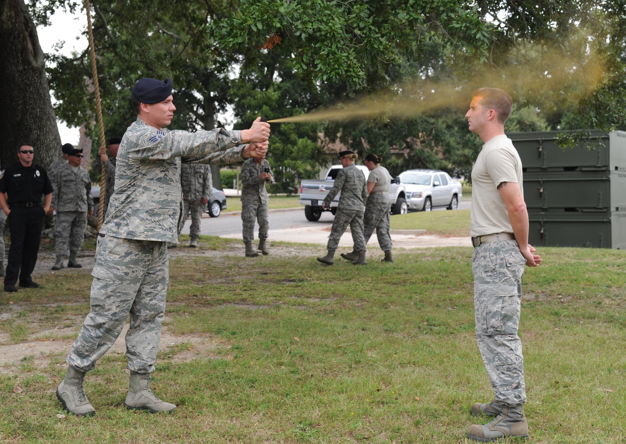 Staff Sgt. Hayden Granger, 81st Security Forces Squadron, exposes Staff Sgt. Bryan Thompson, 81st SFS augmentee, to a spray of oleoresin capsaicin during OC spray training Aug. 28, 2014, at Keesler Air Force Base, Miss.  The training is a required one-time exposure of the OC spray for all Security Forces members.  (U.S. Air Force photo by Kemberly Groue)
