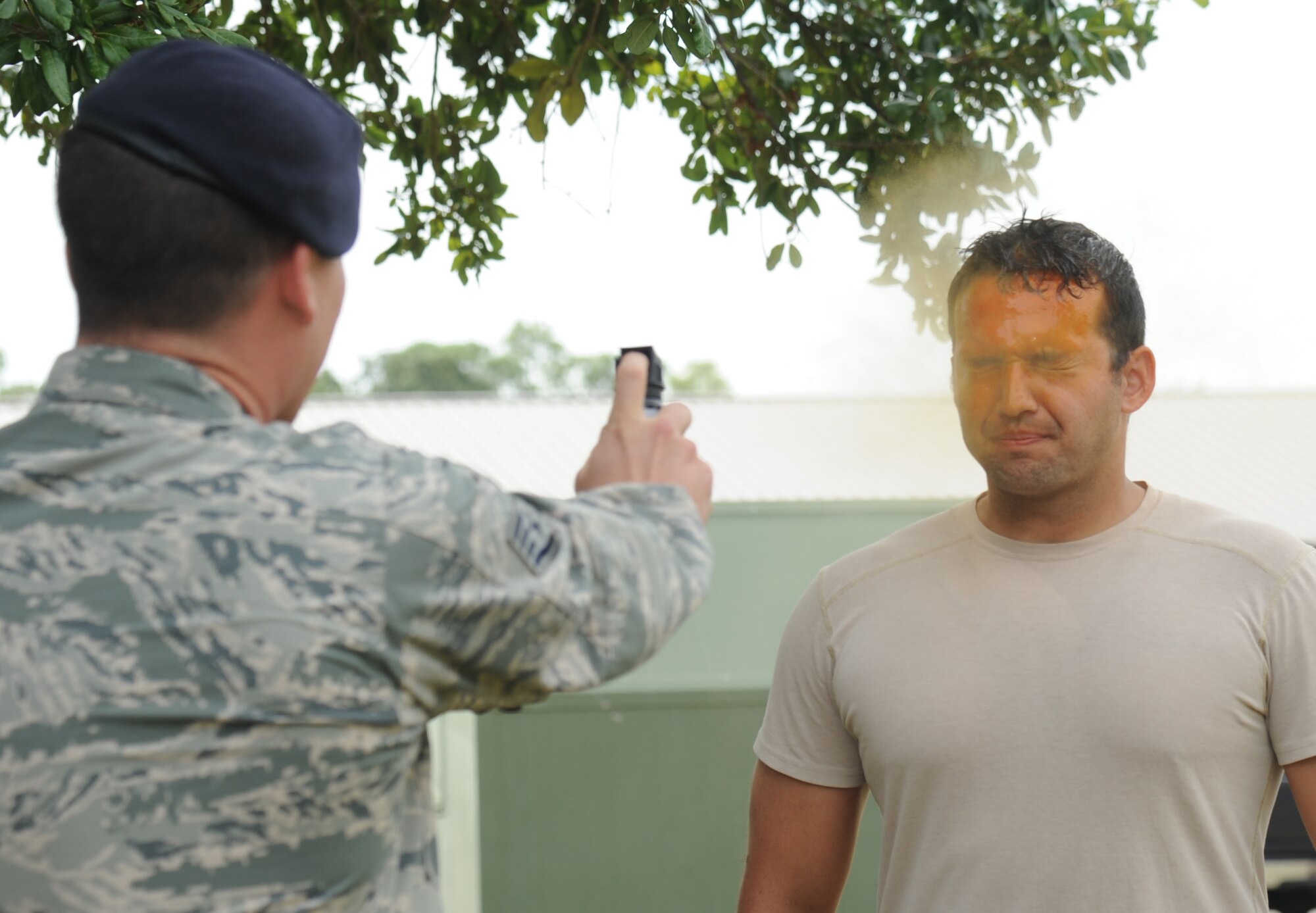 Staff Sgt. Hayden Granger, 81st Security Forces Squadron, exposes Staff Sgt. Seth Beattie, 81st SFS augmentee, to a spray of oleoresin capsaicin during OC spray training Aug. 28, 2014, at Keesler Air Force Base, Miss.  The training is a required one-time exposure of the OC spray for all Security Forces members.  (U.S. Air Force photo by Kemberly Groue)