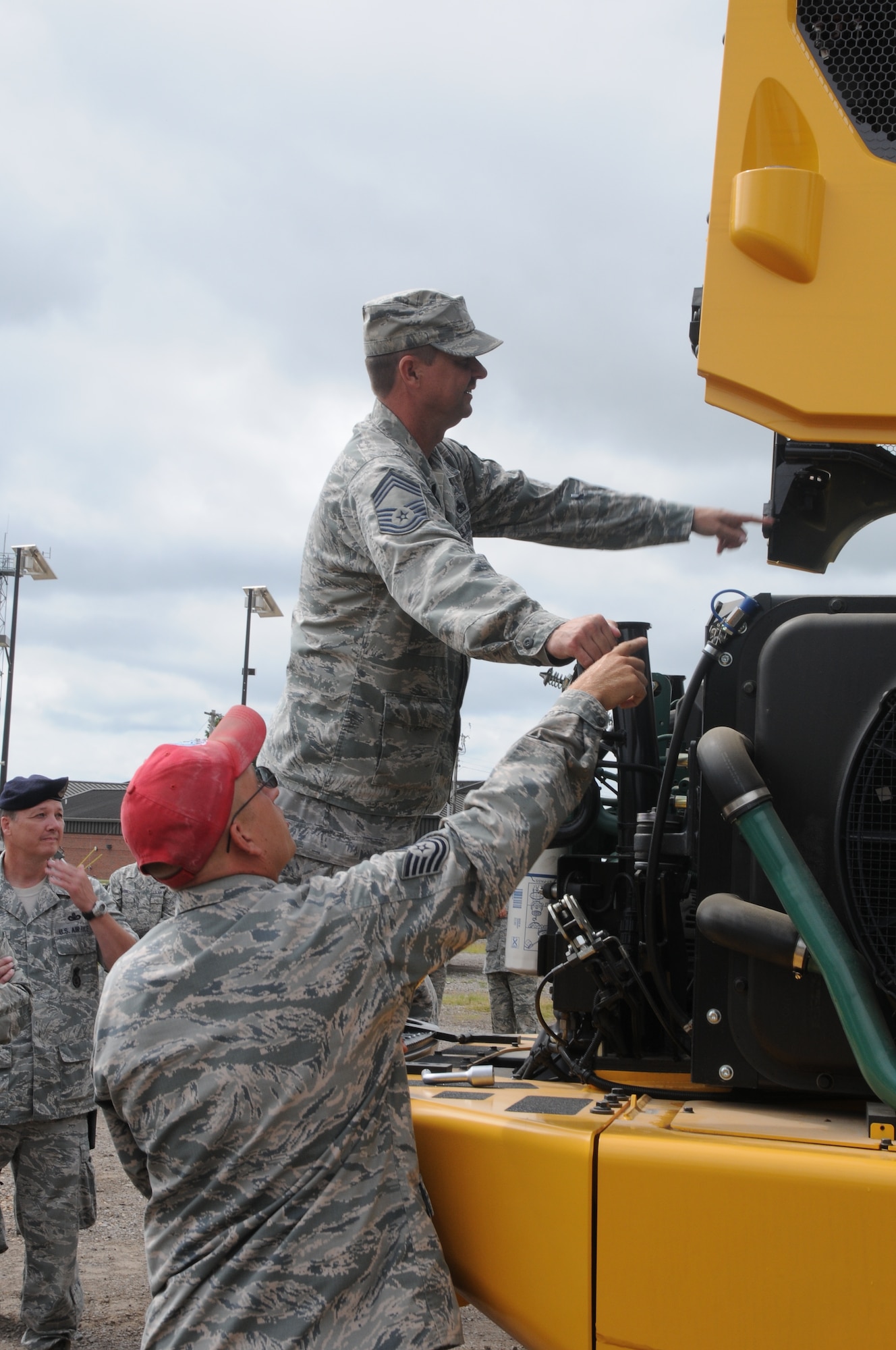 Tech Sgt. Samuel Miller shows Chief Master Sgt. Dee Tankersley the engine of a Volvo 25-ton rock dump truck at Ebbing Air National Guard Base, Fort Smith, Arkansas. The vehicle’s capabilities were showcased during a tour of the 188th Civil Engineering Squadron Rapid Engineer Deployable Heavy Operational Repair Squadron Engineer (REDHORSE) Training Center. The 188th Wing has the Air National Guard’s first and only REDHORSE training center. (U.S. Air National Guard photo by Airman 1st Class Cody Martin/released)  