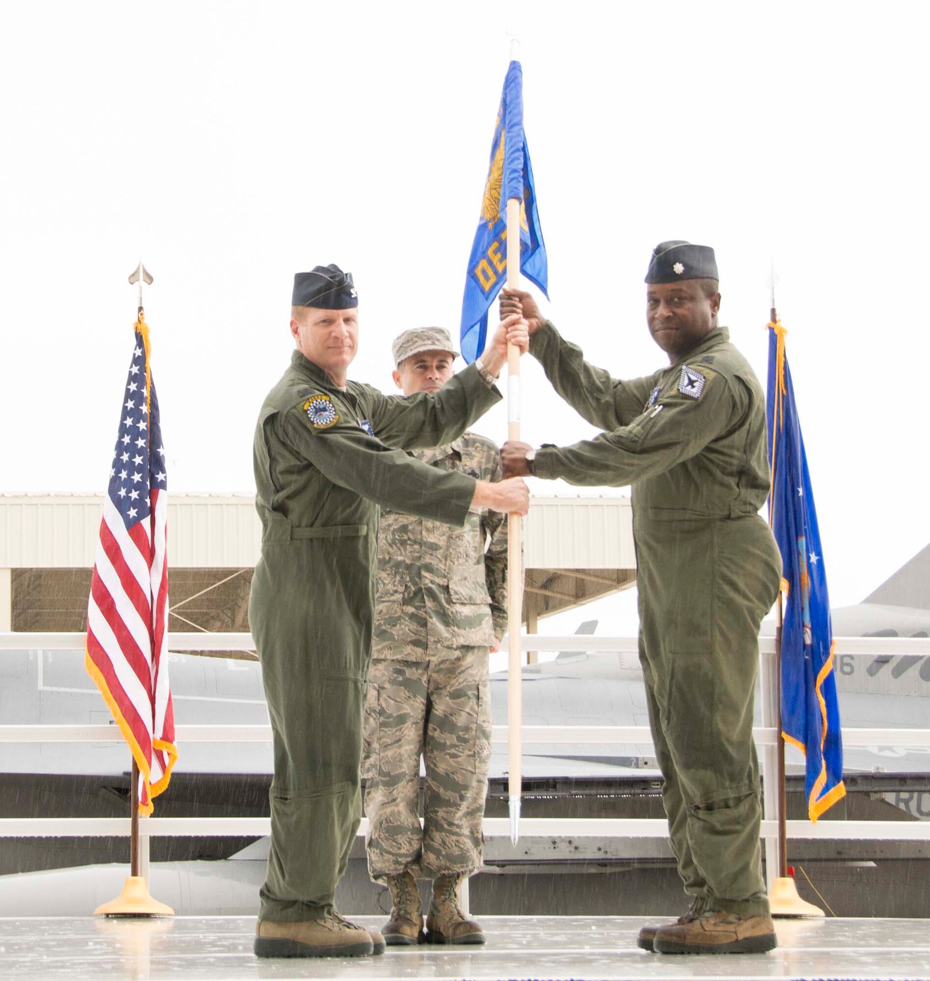 Col. James D. McCune passes the guidon to Lt. Col. Henry R. Jeffress, who took command of Detachment 93, 495th Fighter Group, at Homestead Air Reserve Base, Fla., 28 Aug. As commander Jeffress is responsible for the incorporation of active-duty and reserve members. (Air Force photo/Senior Airman Aja Heiden)