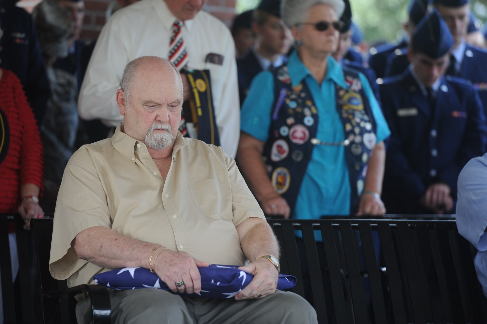 Max C. Peck, Jr., holds the memorial flag for the Forgotten Hero ceremony of Maj. Pierre David Junod, Aug. 28, 2014, at Biloxi National Cemetery. Peck, a fellow parishioner of the Nourishing Place chapel, was Junod’s closest friend. Junod was a U.S. Air Force navigator during the Vietnam War.  (U.S. Air Force photo by Airman 1st Class Stephan Coleman)