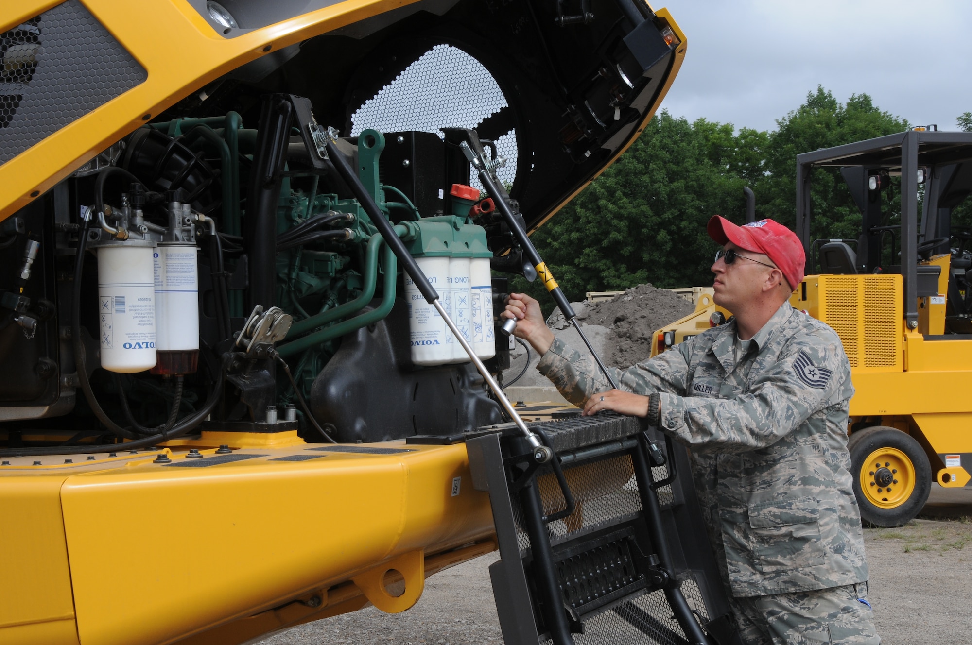 Tech Sgt. Samuel Miller Samuel Miller works on the Volvo 25-ton rock dump truck at Ebbing Air National Guard Base, Fort Smith, Arkansas. The vehicle’s capabilities were showcased during a tour of the 188th Civil Engineering Squadron Rapid Engineer Deployable Heavy Operational Repair Squadron Engineer (REDHORSE) Training Center. The 188th has the Air National Guard’s first and only REDHORSE training center. (U.S. Air National Guard photo by Airman 1st Class Cody Martin/released)
