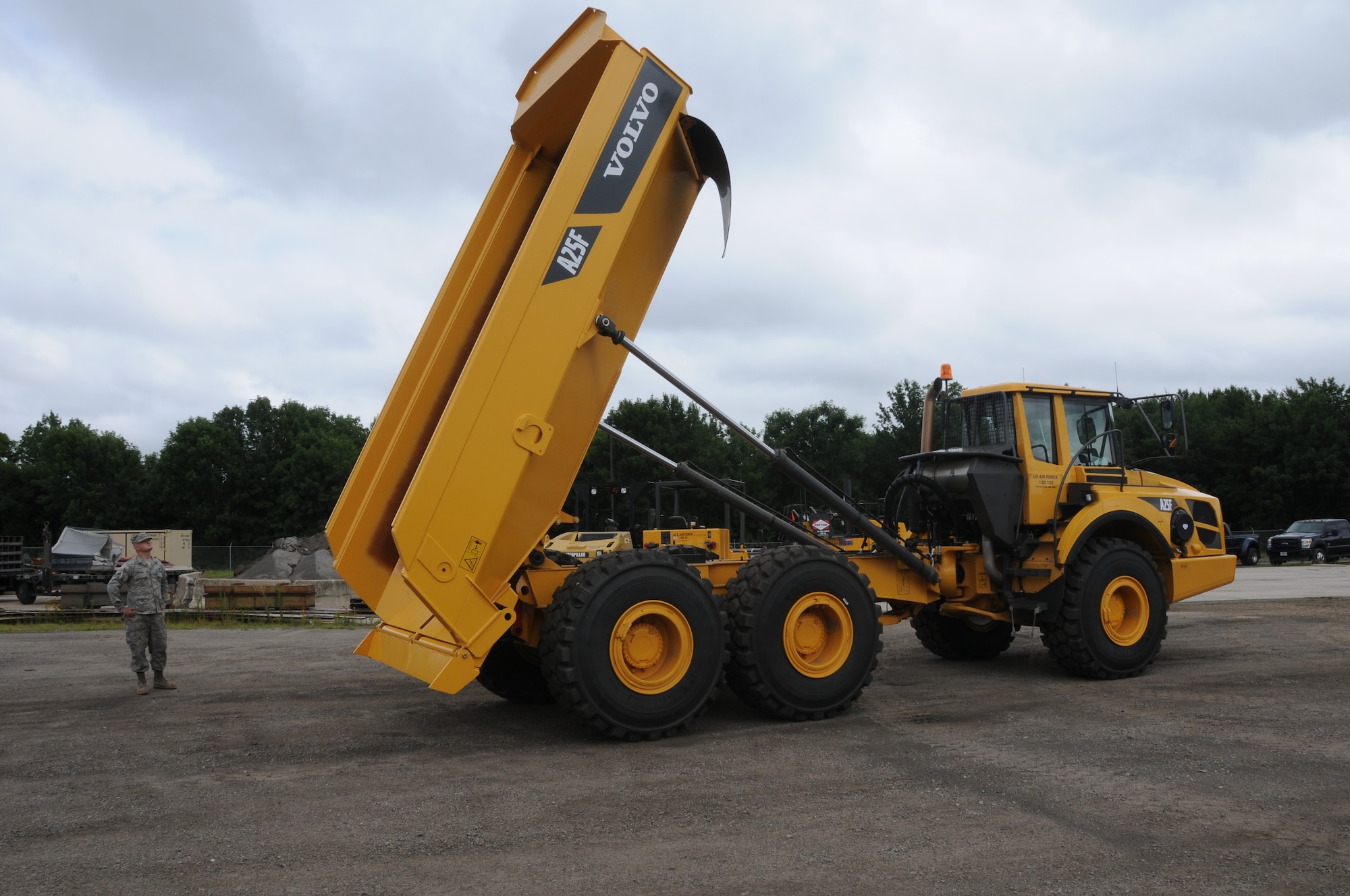 Tech Sgt. Samuel Miller operates the bed of the Volvo 25-ton rock dump truck while Airmen 1st Class Travis Mitchell observes at Ebbing Air National Guard Base, Fort Smith, Arkansas. The vehicle’s capabilities were showcased during a tour of the 188th Civil Engineering Squadron Rapid Engineer Deployable Heavy Operational Repair Squadron Engineer (REDHORSE) Training Center. The 188th has the Air National Guard’s first and only REDHORSE training center. (U.S. Air National Guard photo by Airman 1st Class Cody Martin/released)