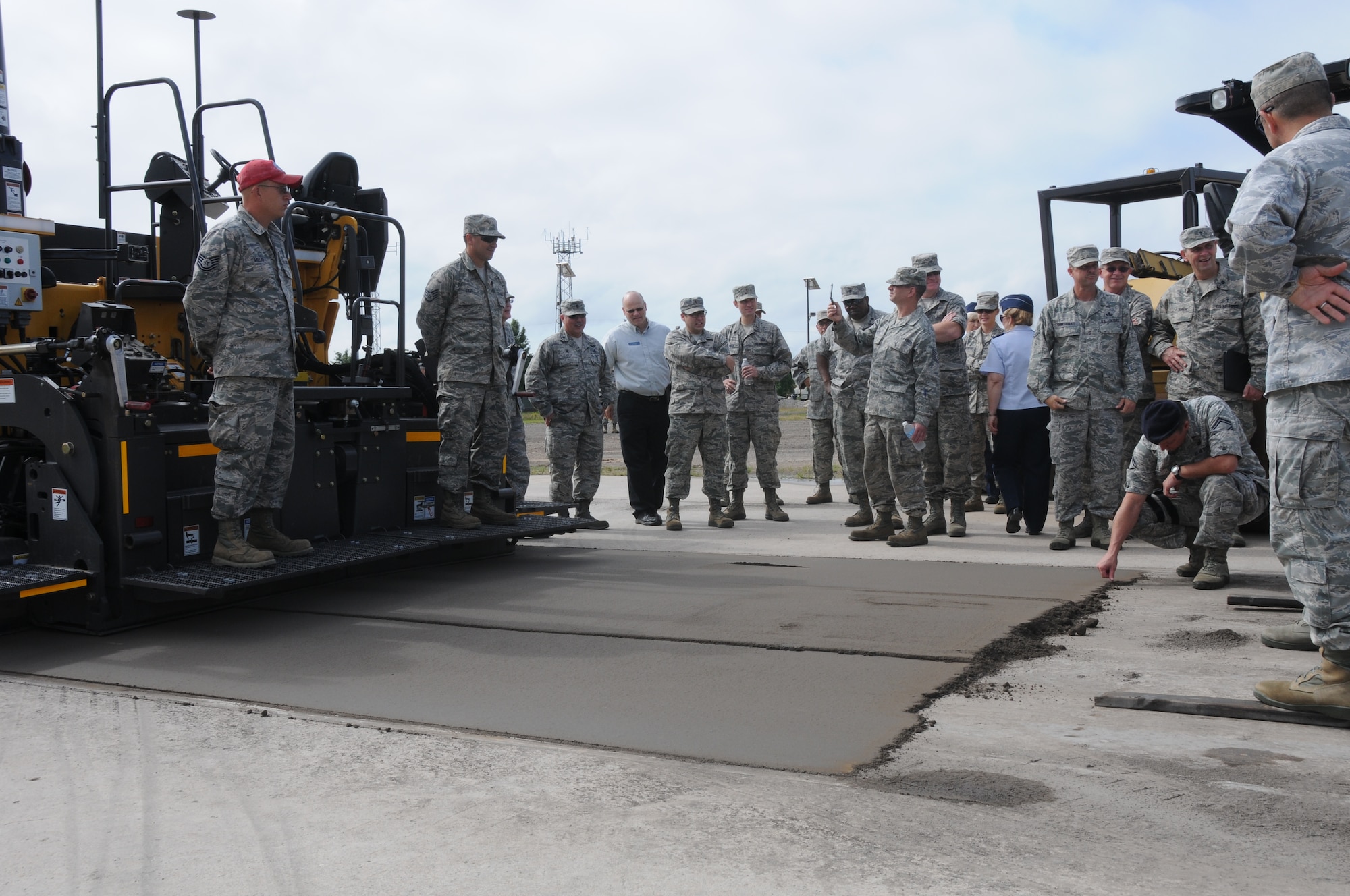 Tech Sergeant Samuel Miller and Staff Sergeant Alcides Silva show members of the 188th Wing the capabilities of the Zimmerman mobile concrete mixing trailer at Ebbing Air National Guard Base, Fort Smith, Arkansas. Silva was driving the mobile concrete mixing trailer to showcase its capabilities during a tour of the 188th Civil Engineering Squadron Rapid Engineer Deployable Heavy Operational Repair Squadron Engineer (REDHORSE) Training Center. The 188th has the Air National Guard's first and only REDHORSE training center. (U.S. Air National Guard photo by Airman 1st Class Cody Martin/released)