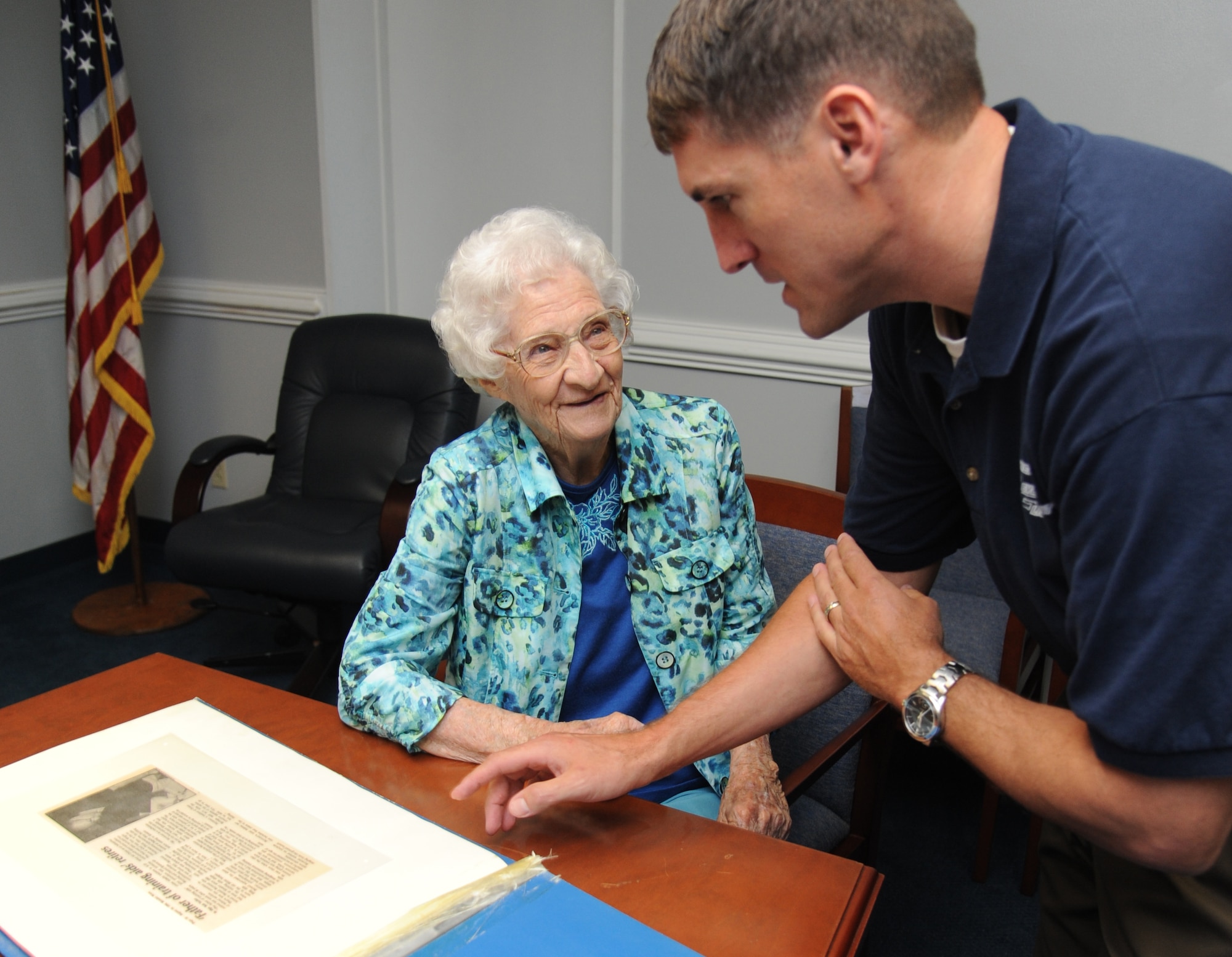 Idella Urie of Biloxi, who celebrates her 100th birthday Sept. 1, goes through a scrapbook with Tomme Lassabe, trainer development flight chief for the 81st Training Support Squadron, during a Sept. 26 visit to Keesler Air Force Base, Mississippi.  Urie came to work at Keesler in 1942 to fabricate and replace plexiglass windshields and windows in aircraft during World War II and went on to develop plastic training aids.  She retired from federal employment at Keesler in 1973, more than 40 years ago. (U.S. Air Force photo by Kemberly Groue)