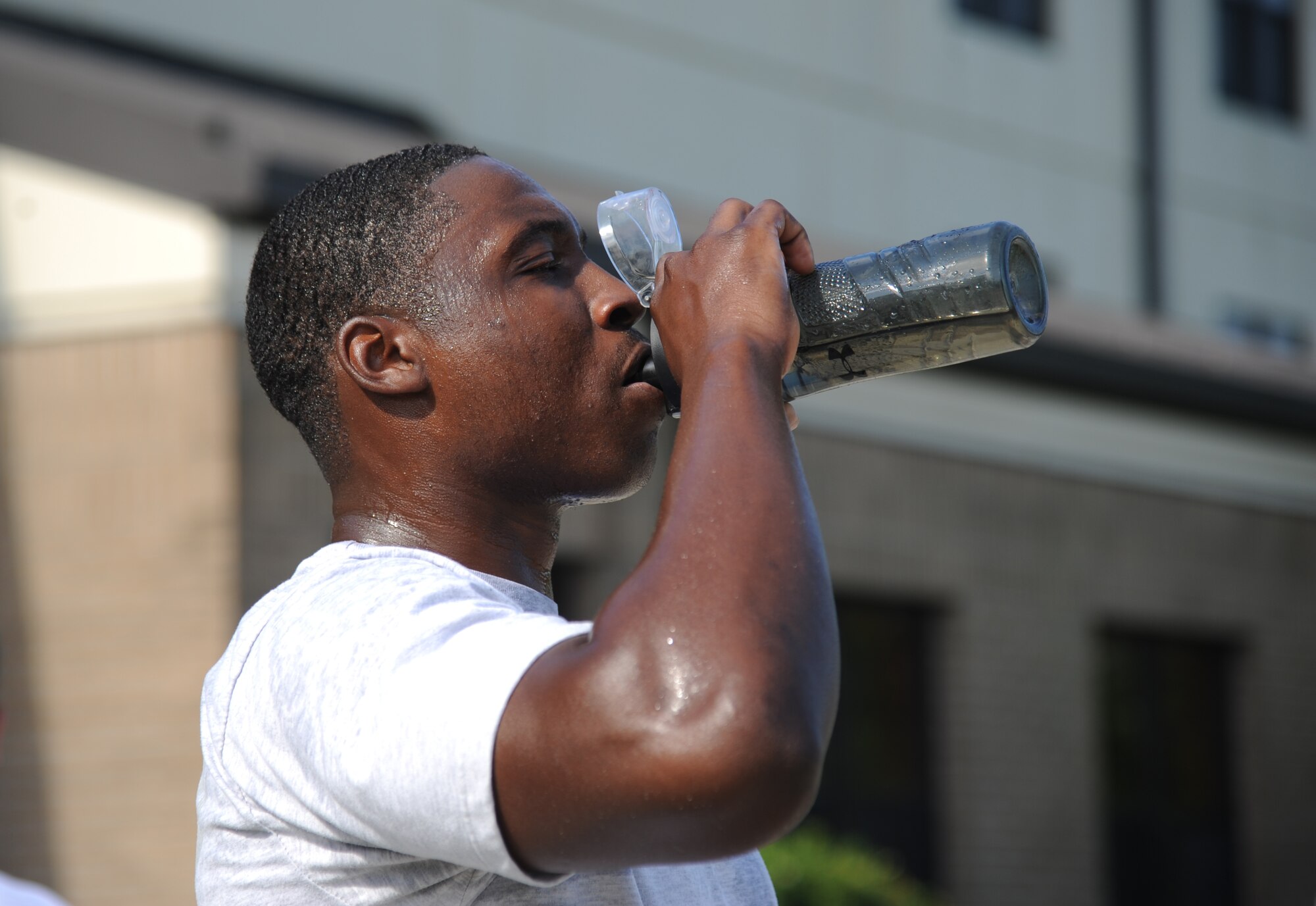 Airman 1st Class Charles Anderson, 338th Training Squadron, stays hydrated during a physical training session Aug. 27, 2014, in the triangle area, Keesler Air Force Base, Miss.  Physical training is a top priority for Airmen to be prepared and equipped for any physical challenge they may face when conducting the mission at home station or in a deployed environment. (U.S. Air Force photo by Kemberly Groue)