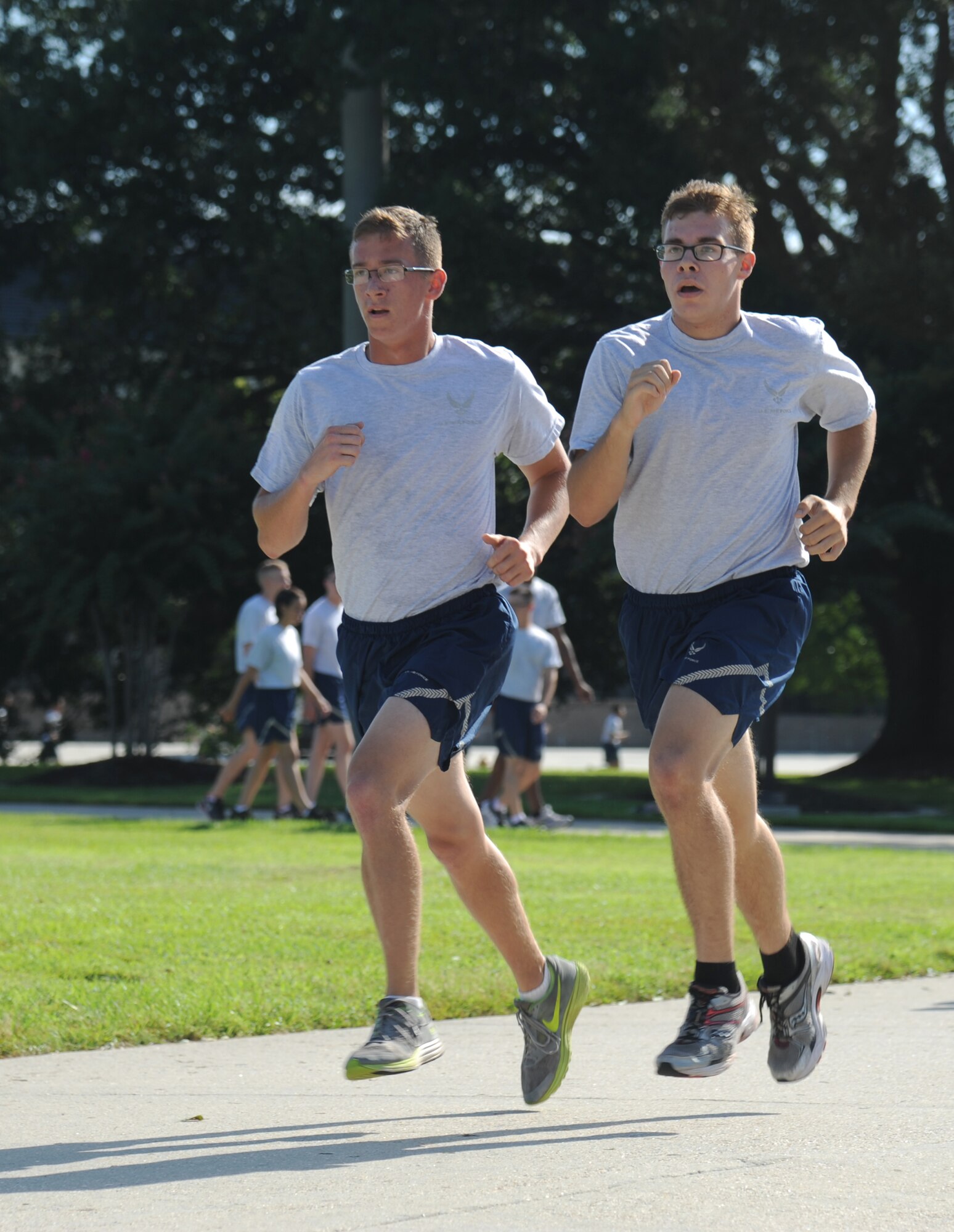 Airman Kurtis Turner and Airman 1st Class Andrew Tomlinson, 338th Training Squadron, run laps during a physical training session Aug. 27, 2014, in the triangle area, Keesler Air Force Base, Miss.  Physical training is a top priority for Airmen to be prepared and equipped for any physical challenge they may face when conducting the mission at home station or in a deployed environment. (U.S. Air Force photo by Kemberly Groue)