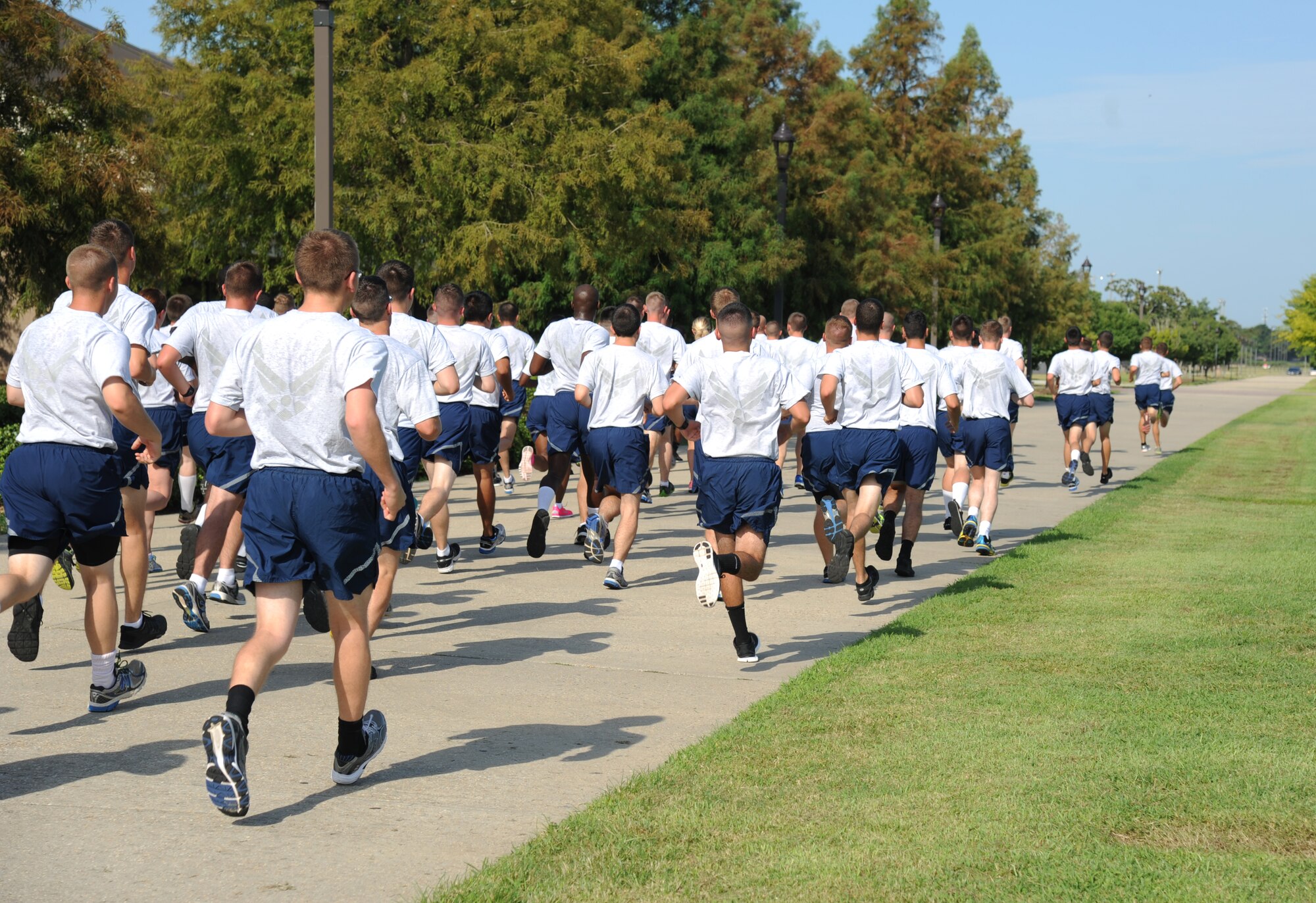 Airmen from the 338th Training Squadron run laps during a physical training session Aug. 27, 2014, in the triangle area, Keesler Air Force Base, Miss.  Physical training is a top priority for Airmen to be prepared and equipped for any physical challenge they may face when conducting the mission at home station or in a deployed environment. (U.S. Air Force photo by Kemberly Groue)