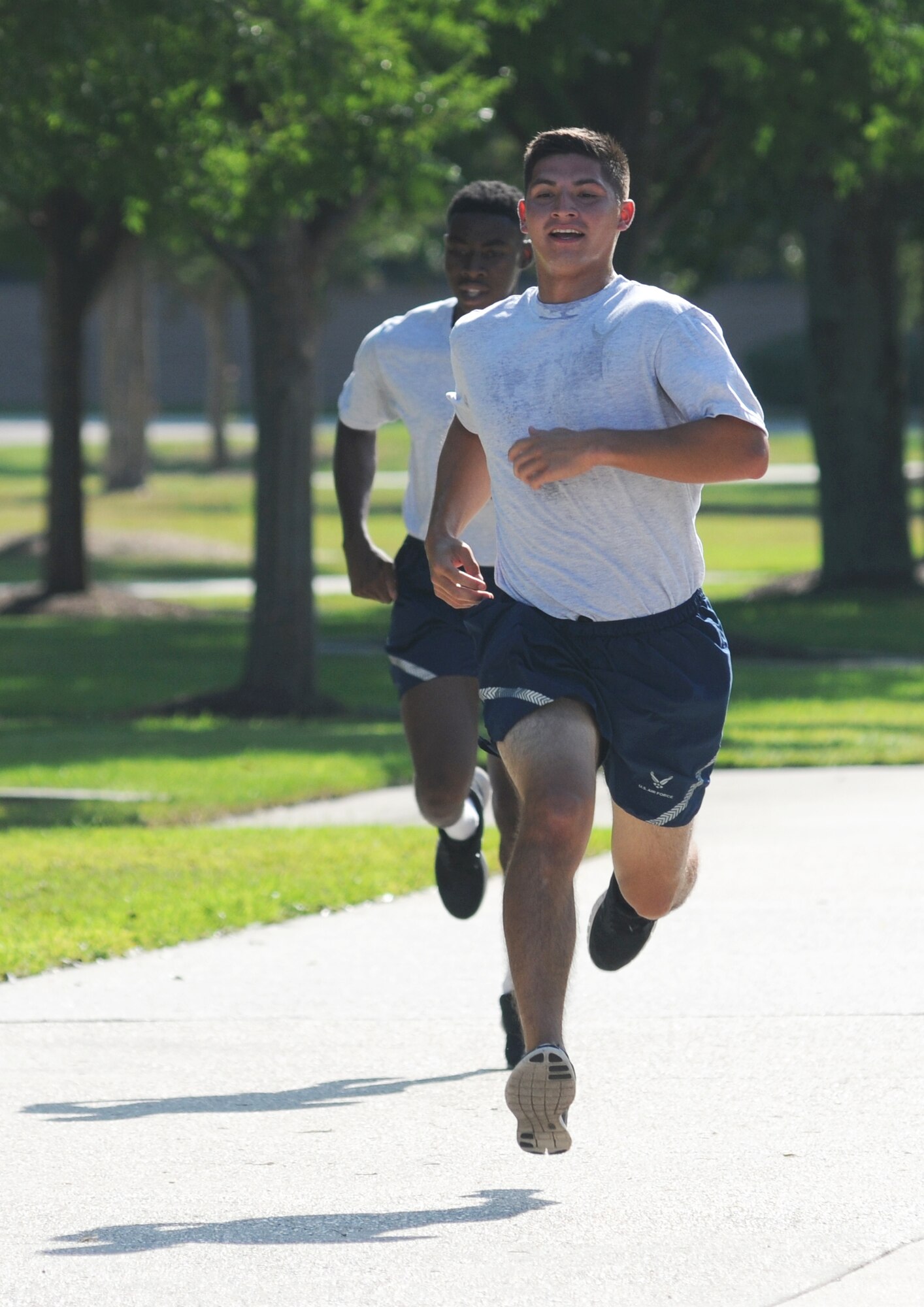 Airman 1st Class Kyshaun Warfield and Airman Alexander Stair, 338th Training Squadron, run laps during a physical training session Aug. 27, 2014, in the triangle area, Keesler Air Force Base, Miss.  Physical training is a top priority for Airmen to be prepared and equipped for any physical challenge they may face when conducting the mission at home station or in a deployed environment.  (U.S. Air Force photo by Kemberly Groue)