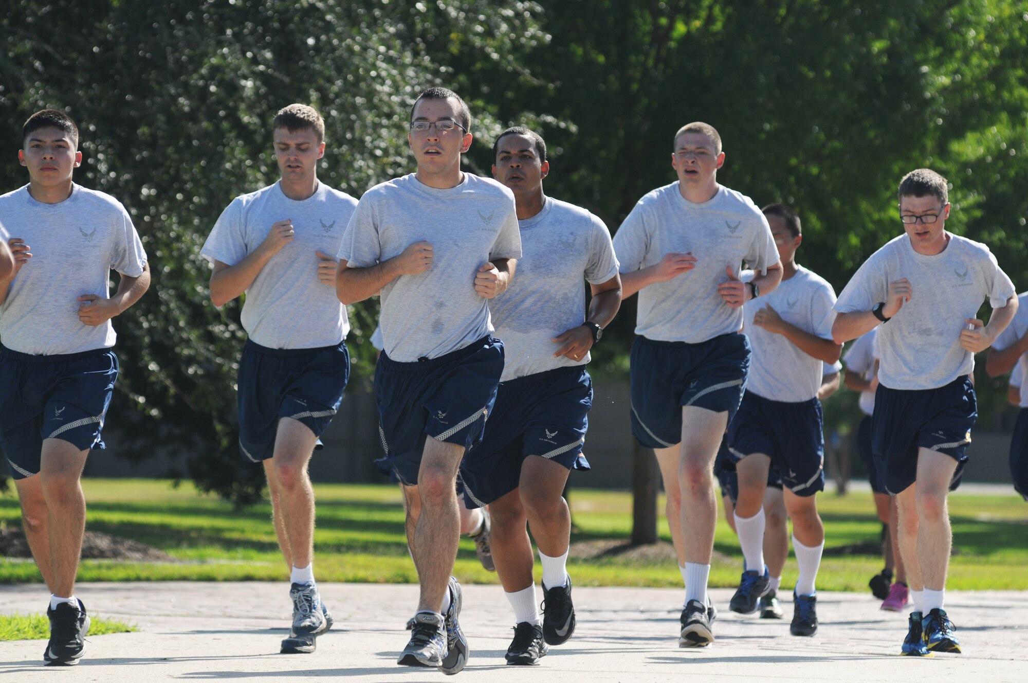 Airmen from the 338th Training Squadron run laps during a physical training session Aug. 27, 2014, in the triangle area, Keesler Air Force Base, Miss.  Physical training is a top priority for Airmen to be prepared and equipped for any physical challenge they may face when conducting the mission at home station or in a deployed environment.  (U.S. Air Force photo by Kemberly Groue)