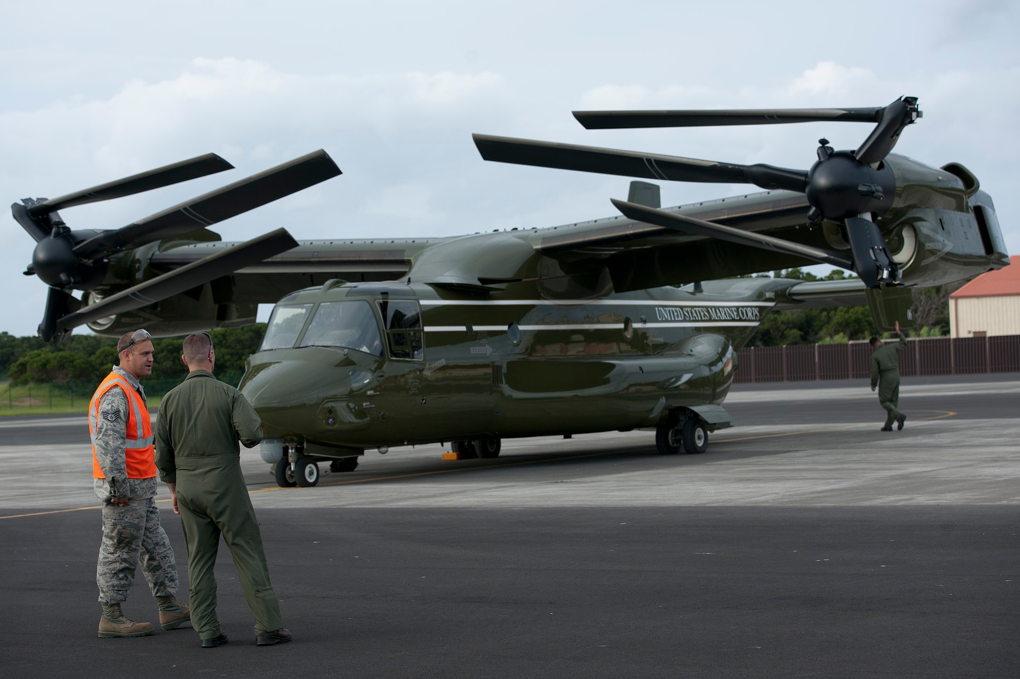 U.S. Air Force Staff Sgt. Kyle Porter, left, 65th Operations Support Squadron coronet liaison and F-16 crew chief, talks with a U.S. Marine MV-22B Osprey pilot Aug. 26, 2014, Lajes Field, Azores, Portugal. The Marines are assigned to Marine Helicopter Squadron One, Marine Corps Base Quantico, Va. Marines assigned to HMX-1 provide Presidential and VIP support in addition to their primary role as the Operational Test and Evaluation unit for Marine assault support helicopters and related equipment. (U.S. Air Force Photo by Tech. Sgt. Paul Villanueva II/Released)