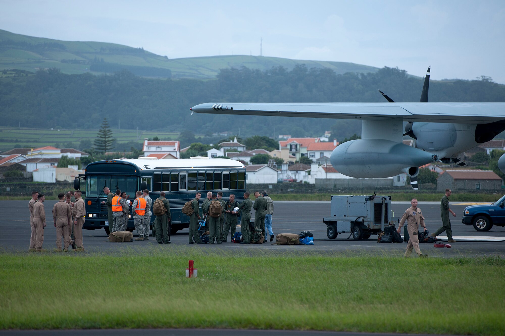 U.S. Marines from Marine Helicopter Squadron One, Marine Corps Base Quantico, Va. wait to board buses after arriving Aug. 26, 2014, Lajes Field, Azores, Portugal. Marines assigned to HMX-1 provide Presidential and VIP support in addition to their primary role as the Operational Test and Evaluation unit for Marine assault support helicopters and related equipment. (U.S. Air Force photo by Tech. Sgt. Paul Villanueva II/Released)