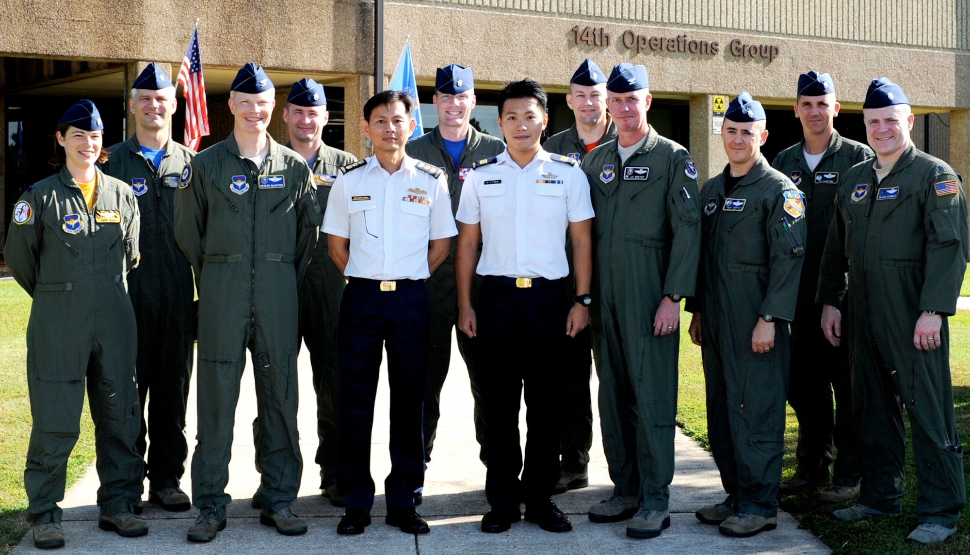 Col. Pek Hong Hwa, Republic of Singapore Flying Training Institute Commander, and Capt. Cher Lester, Republic of Singapore staff officer, stand with base leadership and 14th Operations Group personnel at Columbus Air force Base, Aug. 22. During the visit they toured the training squadrons to see pilot training firsthand and get a better understanding of what their personnel experience during pilot training. (U.S. Air Force photo/ Elizabeth Owens)