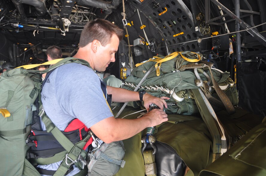 Tech Sgt. Jason Brolin, a pararescueman for the 308th Rescue Squadron, inspects a rigging alternate method zodiac (RAMZ), which is a packaged cargo cube containing an inflatable, motorized Zodiac boat that is dropped from a plane. The training is part of a rescue jumpmaster course being hosted by the 920th Rescue Wing, the Air Force Reserve’s only combat rescue unit. (U.S. Air Force photo/ Tech. Sgt. Katie Spencer)