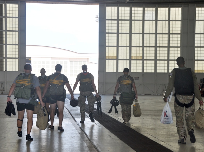 Pararescuemen walk out of the hangar and to the flightline, August 21. The Air Force Reserve’s only combat rescue unit, the 920th Rescue Wing, is hosting a rescue jumpmaster course for Active Duty, Guard and Reserve. (U.S. Air Force photo/ Tech. Sgt. Katie Spencer) 
