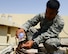 U.S. Air Force Staff Sgt. Gerald Leon Guerrero, 379th Expeditionary Civil Engineer heating ventilation and air conditioning craftsman, pours soapy water onto copper pipes at Al Udeid Air Base, Qatar, Aug. 28, 2014. The soapy water creates bubbles that indicate where there a leak may originate in the pipes. Leon Guerrero is from Tamuning, Guam, and is deployed from Cannon Air Force Base, New Mexico. (U.S. Air Force photo by Staff Sgt. Ciara Wymbs/Released)