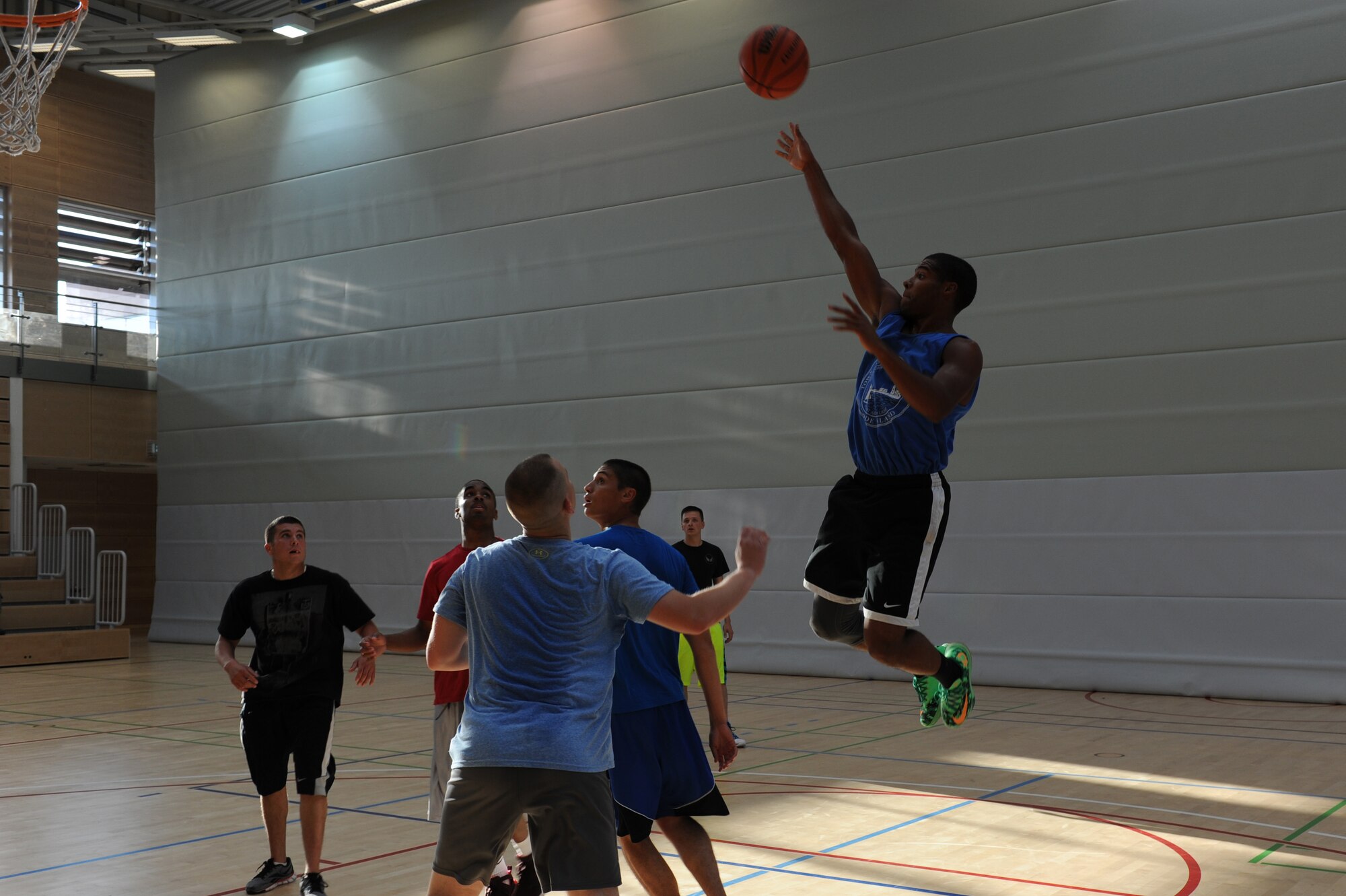 U.S. Air Force Airman 1st Class Deamontee Cawley, a 52nd Equipment Maintenance Squadron aircraft armament systems apprentice from North Kingstown, R.I., shoots a floater during the three-on-three basketball tournament for the second annual Dorm Wars competition Aug. 28, 2014, at Spangdahlem Air Base, Germany.  The teams played 15-minute games with the team leading at the end determined as the winner. (U.S. Air Force photo by Airman 1st Class Dylan Nuckolls/Released)