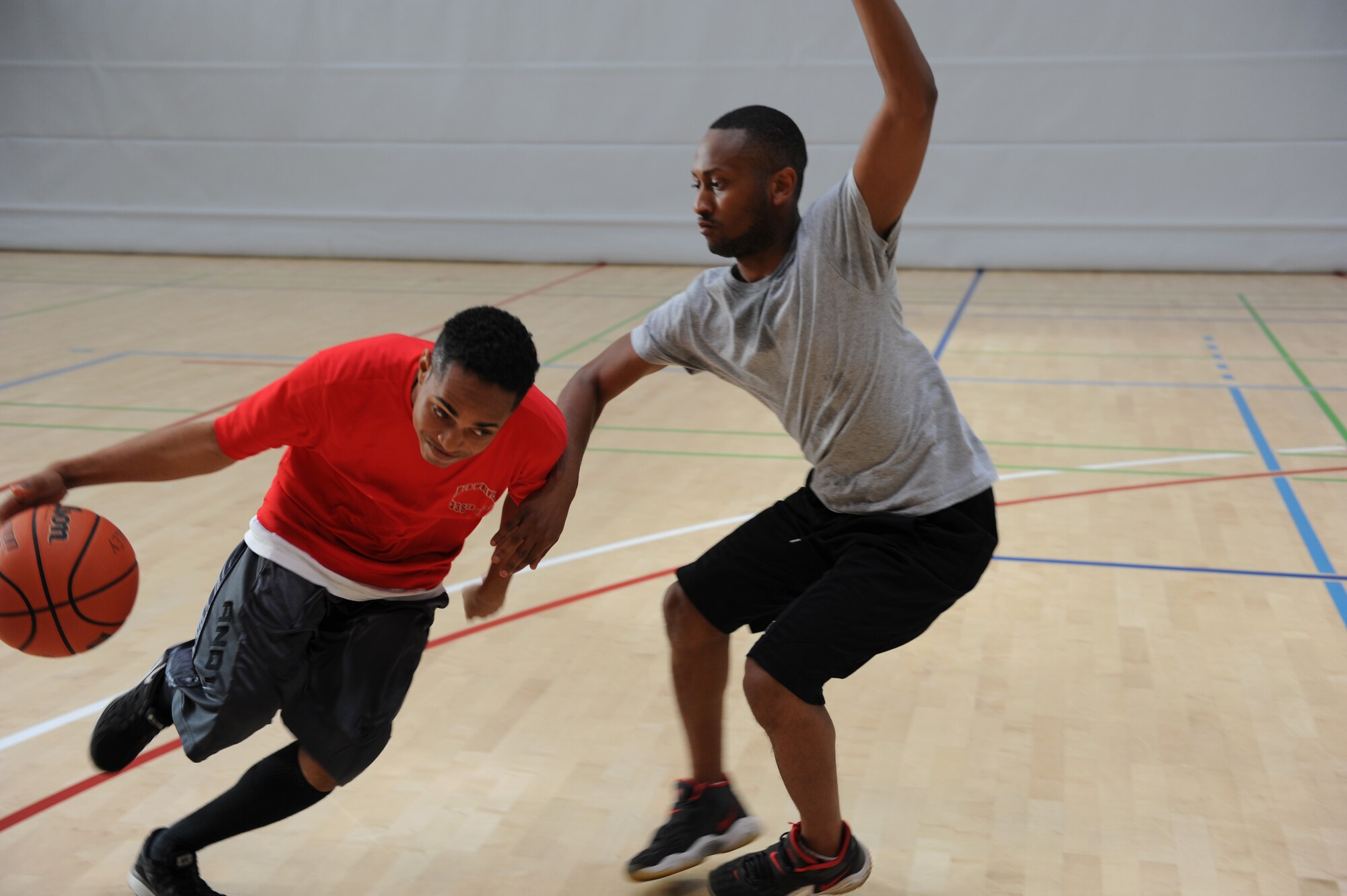 U.S. Air Force Airman 1st Class Brandon Smith, a 52nd Communication Squadron knowledge enterprise management apprentice from Los Angeles, drives to the basketball hoop during the three-on-three basketball tournament at the second annual Dorm Wars competition Aug. 28, 2014, at Spangdahlem Air Base, Germany. The 16 events ranged from basketball to paintball and a trivia contest. (U.S. Air Force photo by Airman 1st Class Dylan Nuckolls/Released)