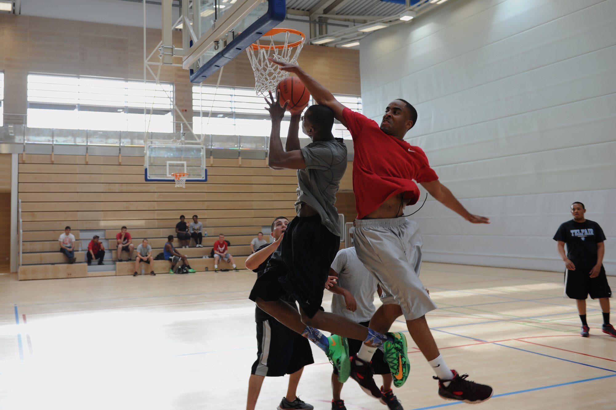 A U.S. Air Force Airman tries to block a shot during the three-on-three basketball tournament for the second annual Dorm Wars competition Aug. 28, 2014, at Spangdahlem Air Base, Germany. Dormitory 227 took home the A-10 gun barrel traveling trophy after the first Dorm Wars competition. (U.S. Air Force photo by Airman 1st Class Dylan Nuckolls/Released)