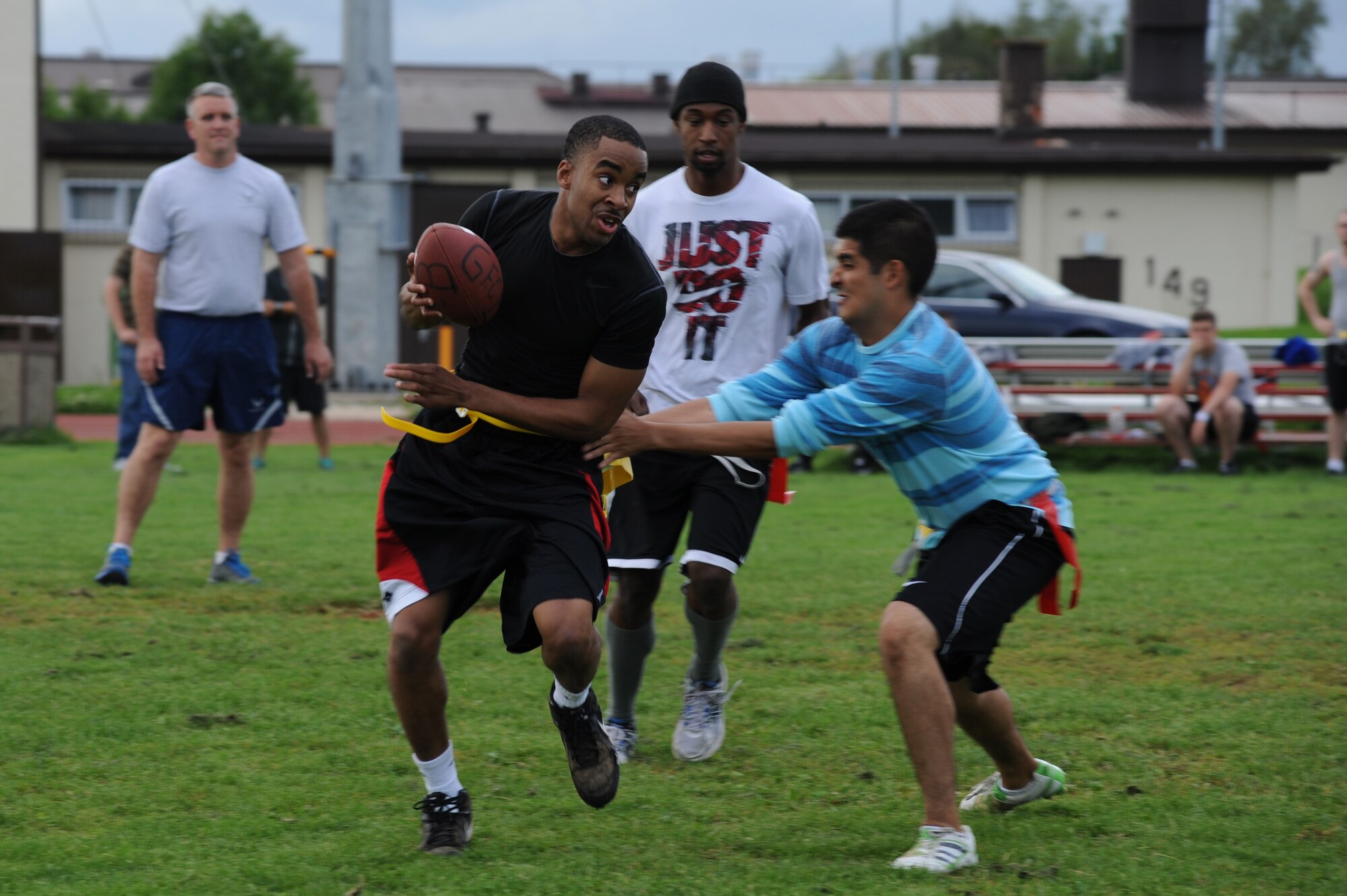 U.S. Air Force Airmen compete in flag football during the second annual Dorm Wars competition Aug. 26, 2014, at Spangdahlem Air Base, Germany. Squadron leadership came out to support their Airmen and also earned their Airmen’s dormitory bonus points. (U.S. Air Force photo by Airman 1st Class Dylan Nuckolls/Released)