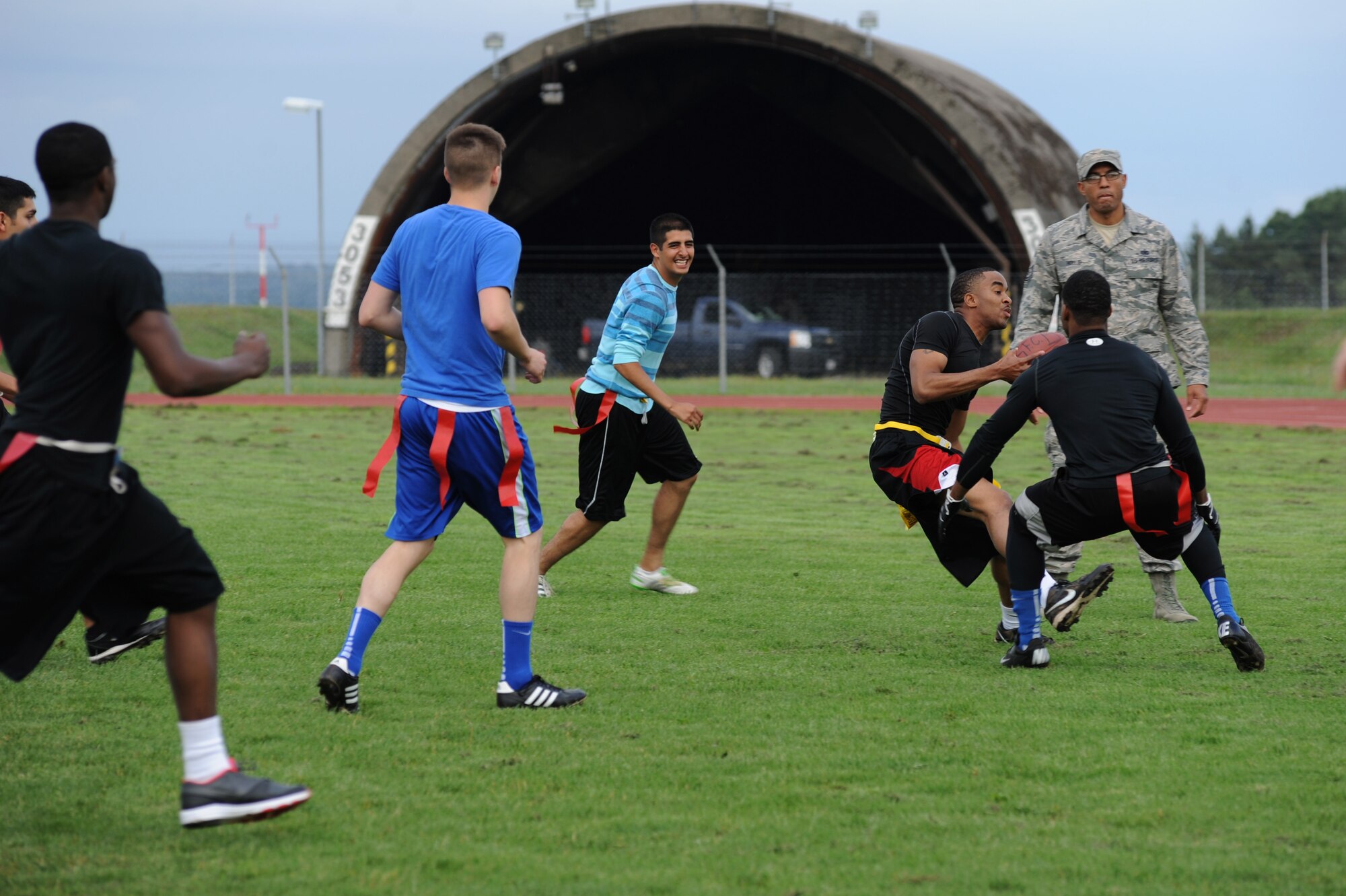 U.S. Air Force Airmen compete in flag football during the second annual Dorm Wars competition Aug. 26, 2014, at Spangdahlem Air Base, Germany.  The championship game consisted of two 15-minute halves. (U.S. Air Force photo by Airman 1st Class Dylan Nuckolls/Released)