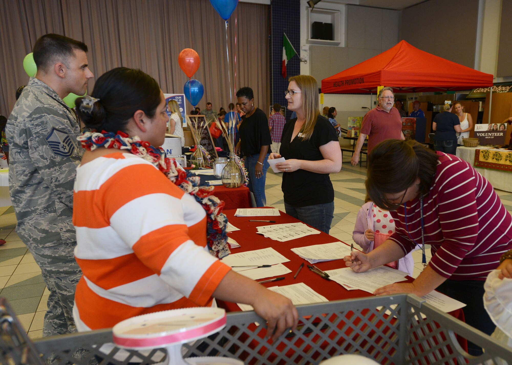 Parents visit various booths at the information fair during the “Back to School Bash,” Aug. 28, 2014, at Aviano Air Base, Italy. The information fair was comprised of informational and programs booths to inform parents and families for the upcoming school year. (U.S. Air Force photo/Airman 1st Class Deana Heitzman)