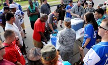Airmen competed against each other during a fear factor-like challenge during the 1st Annual Luau block party at Kunsan Air Base, Republic of Korea, Aug. 22, 2014. The Luau started with a parade and afterwards, the Airmen challenged each other in games and events. The event was held to boost morale and bring the Wolf Pack community together for an evening of fun and esprit-de-corps. (U.S. Air Force photo by Senior Airman Divine Cox/Released)
