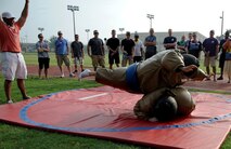 Wolf Pack Airmen battle it out in sumo wrestling during the 1st Annual Luau block party at Kunsan Air Base, Republic of Korea, Aug. 22, 2014. The Luau started with a parade and afterwards, the Airmen challenged each other in games and events. The event was held to boost morale and bring the Wolf Pack community together for an evening of fun and esprit-de-corps. (U.S. Air Force photo by Senior Airman Divine Cox/Released)