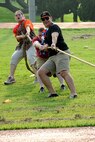 Wolf Pack Airmen test their combined strength at a tug-o-war competition during the 1st Annual Luau block party at Kunsan Air Base, Republic of Korea, Aug. 22, 2014. The Luau started with a parade and afterwards, the Airmen challenged each other in games and events. The event was held to boost morale and bring the Wolf Pack community together for an evening of fun and esprit-de-corps. (U.S. Air Force photo by Senior Airman Divine Cox/Released)