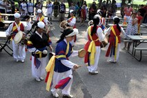 Traditional Korean dancers perform in the 1st Annual Luau block party parade at Kunsan Air Base, Republic of Korea, Aug. 22, 2014. The Luau started with a parade and afterwards, the Airmen challenged each other in games and events. The event was held to boost morale and bring the Wolf Pack community together for an evening of fun and esprit-de-corps. (U.S. Air Force photo by Senior Airman Divine Cox/Released)