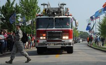 Wolf Pack firemen participate in a parade during the 1st Annual Luau block party at Kunsan Air Base, Republic of Korea, Aug. 22, 2014.  The Luau started with a parade and afterwards, the Airmen challenged each other in games and events. The event was held to boost morale and bring the Wolf Pack community together for an evening of fun and esprit-de-corps.  (U.S. Air Force photo by Senior Airman Divine Cox/Released)