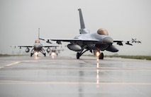 F-16 Fighting Falcons from Kunsan Air Base and South Korean KF-16s taxi to the runway together during Exercise Buddy Wing 14-8 at Seosan Air Base, Republic of Korea Aug. 21, 2014. The purpose of the exercise was not only to improve interoperability between U.S. Air Force and ROKAF fighter squadrons, but to practice with ROKAF KF-16 units for their first upcoming RED FLAG exercise in Alaska. (U.S. Air Force photo by Senior Airman Taylor Curry/Released)