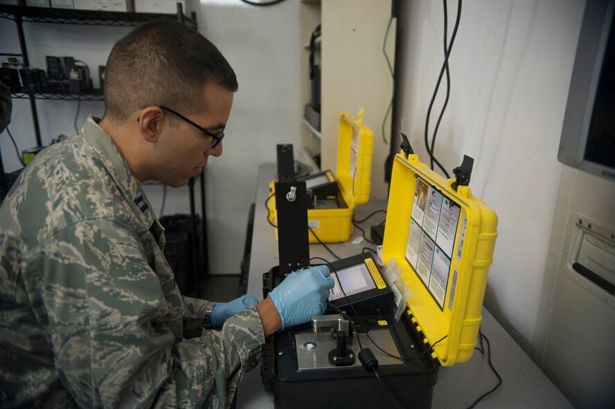 Capt. Lester Morales Vazquez, 51st Aerospace Medicine Squadron chief of bioenvironmental operations, uses a HAZMATID 360 system at Osan Air Base, Republic of Korea, Aug. 27, 2014. This device uses Fourier-Transform Infrared Spectroscopy and an extensive on-board spectral library to rapidly identify chemicals in unknown solids and liquids base on their distinct molecular fingerprints. (U.S. Air Force photo by Senior Airman Matthew Lancaster/Released)