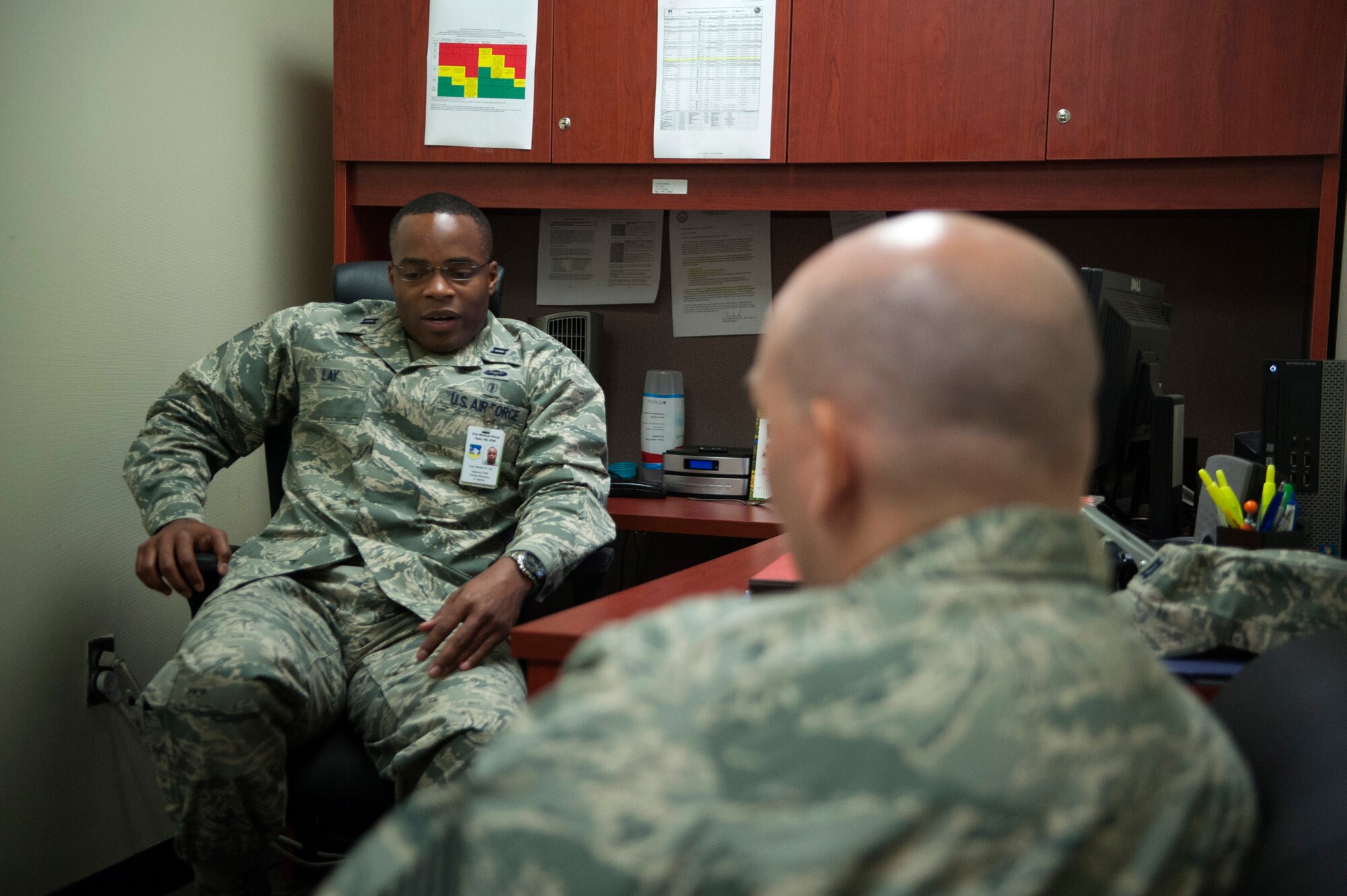 Capt. Raheem Lay, 51st Medical Operations Squadron family advocacy program chief, talks with a patient at Osan Air Base, Republic of Korea, Aug. 27, 2014. The family advocacy program is a part of mental health and is dedicated to domestic violence prevention, spousal, and child abuse prevention, education, prompt reporting, intervention and treatment. (U.S. Air Force photo by Senior Airman Matthew Lancaster/Released)
