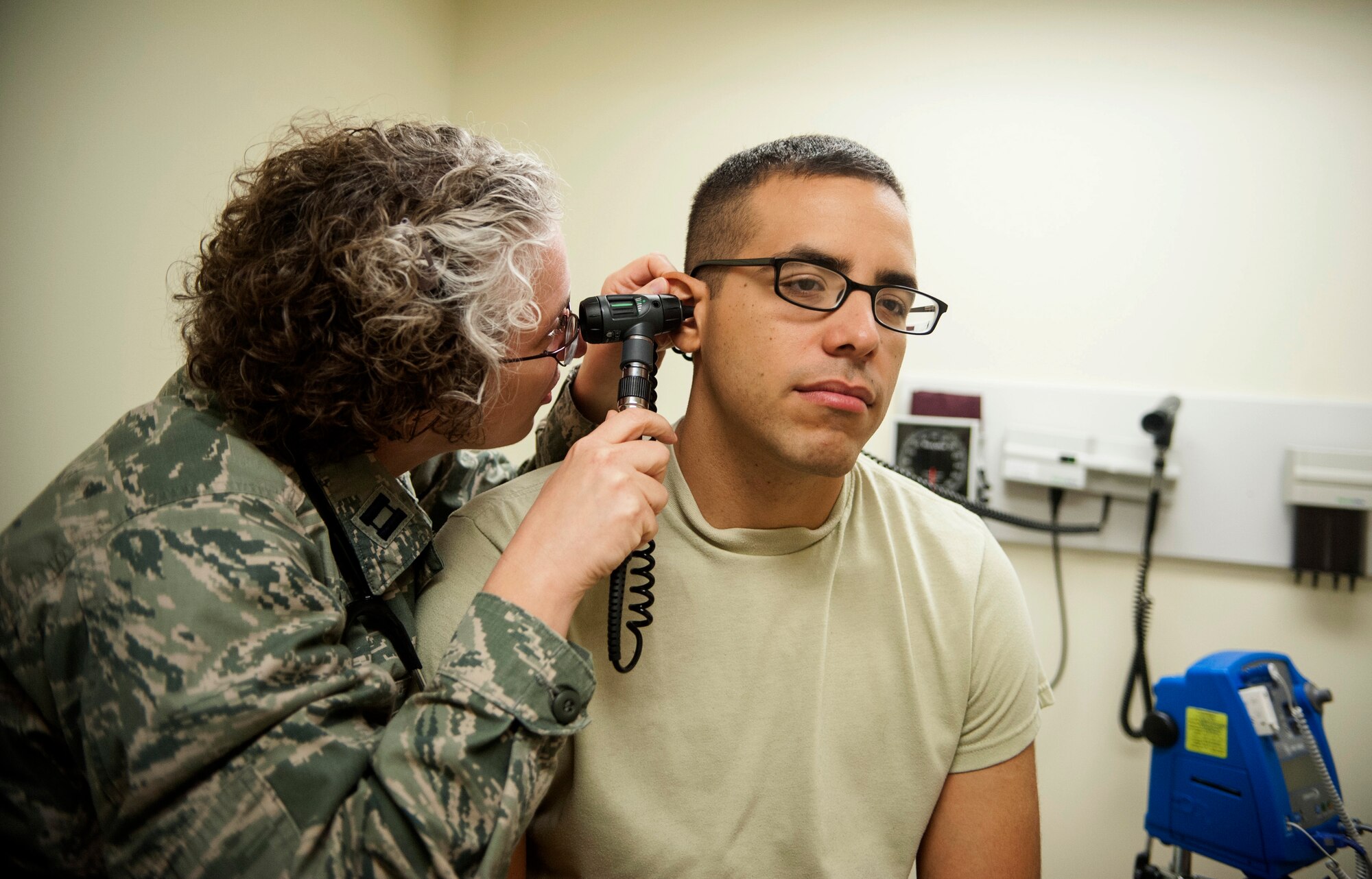 Capt. Candra Case, 51 Medical Operations Squadron physician assistant, looks into the ear of Capt. Lester Morales Vazquez, 51st Aerospace Medicine Squadron chief of bioenvironmental operations, at Osan Air Base, Republic of Korea, Aug. 27, 2014. Physician assistants examine patients, diagnose injuries and illnesses, such as the flu or a broken bone, and provide treatment for them. (U.S. Air Force photo by Senior Airman Matthew Lancaster/Released)