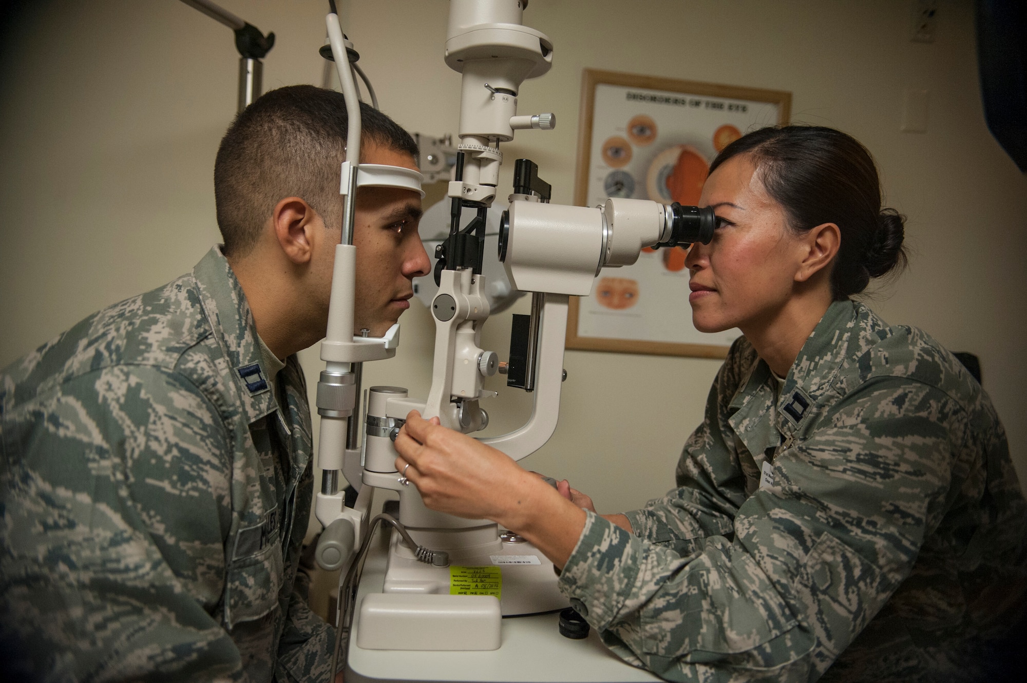 Capt. See Vang, 51st Aerospace Medicine Squadron optometrist (right), gives an eye exam to Capt. Lester Morales Vazquez, 51st AMDS chief of bioenvironmental operations, at Osan Air Base, Republic of Korea, Aug. 27, 2014. Patients who wear glasses or contacts should receive an eye exam every one to two years. If the exam determines that your eyesight has changed, the optometrist will prescribe new glasses. (U.S. Air Force photo by Senior Airman Matthew Lancaster/Released)