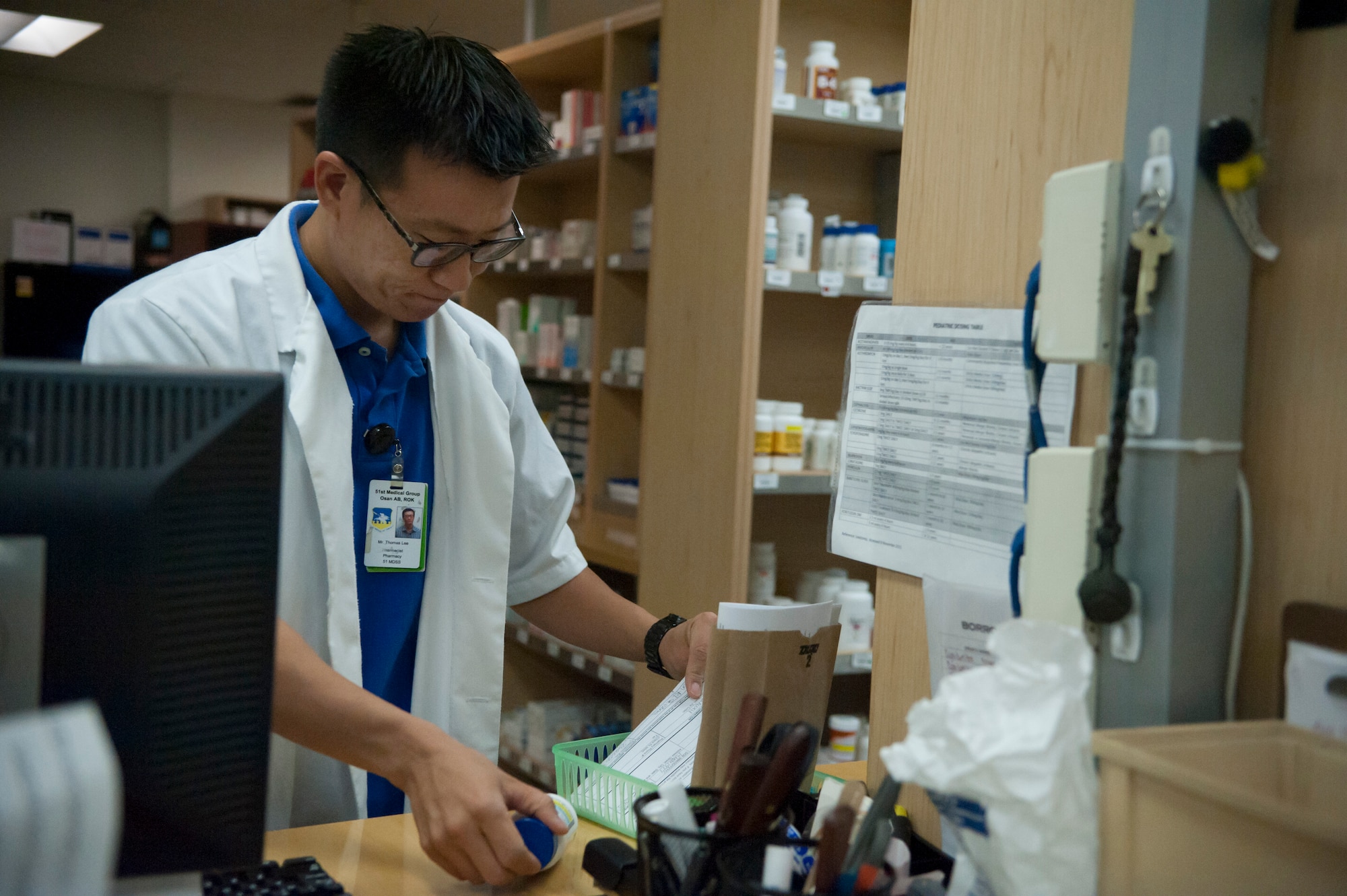 Thomas Lee, 51st Medical Support Squadron pharmacist, checks prescription labels at Osan Air Base, Republic of Korea, Aug. 27, 2014. Pharmacists check labels to make sure that patients receive the proper amount of medicine and that the dosage amount is correct. (U.S. Air Force photo by Senior Airman Matthew Lancaster/Released)