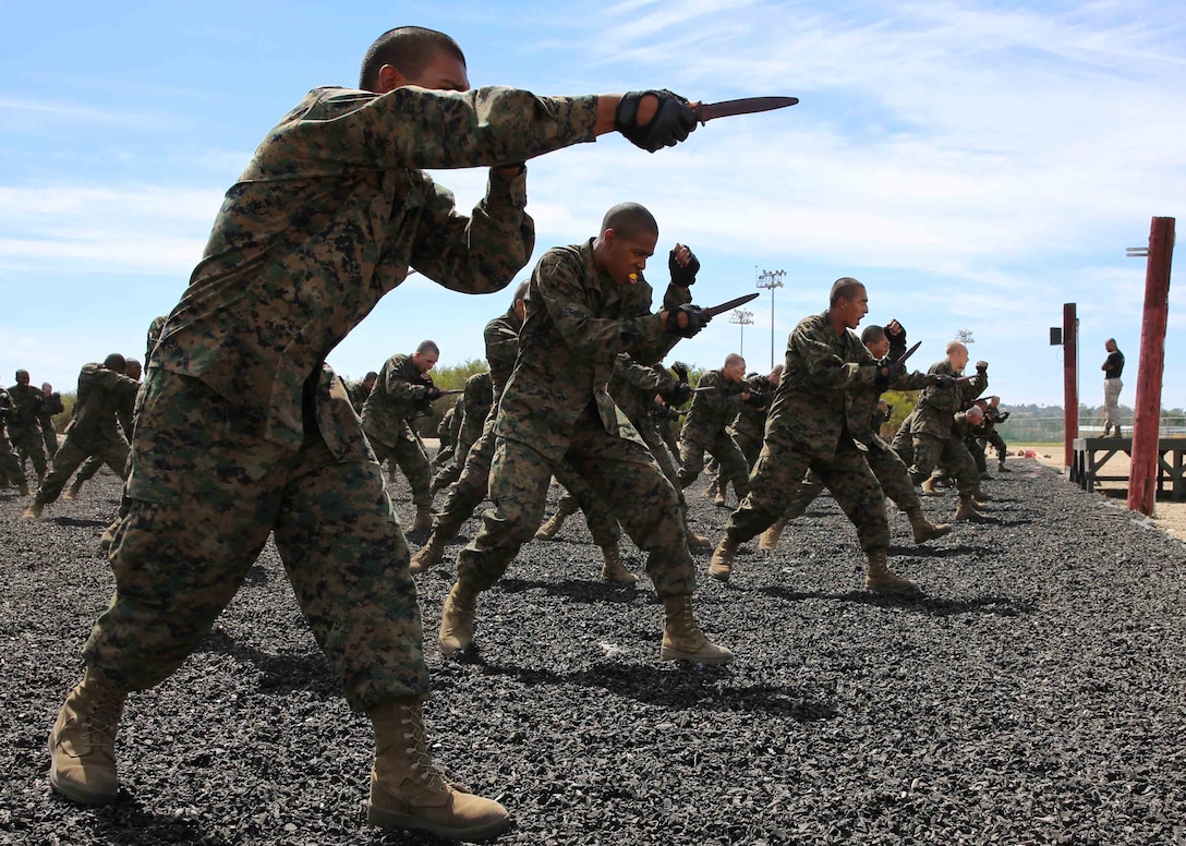 Recruits of Bravo Company, 1st Recruit Training Battalion, practice the forward thrust knife technique during a Marine Corps Martial Arts Program session at Marine Corps Recruit Depot San Diego, Calif., Aug. 25. To earn each belt, Marines are tested on different MCMAP moves that apply to that particular belt level.