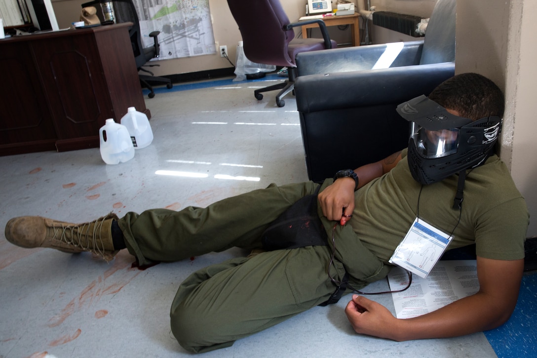 Lance Cpl. Robert Lee, a mock victim for an active shooter exercise, called “Operation Social Fury,” plays the role of an injured coworker during the exercise aboard Marine Corps Air Station Miramar, Calif., Aug. 27. The exercise began with a disgruntled Marine who threatened in a Facebook post to kill his peers at the Recycling Center.