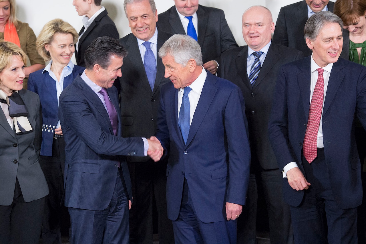NATO Secretary General Anders Fogh Rasmussen, left, shakes hands with Defense Secretary Chuck Hagel in February 2014. NATO courtesy photo