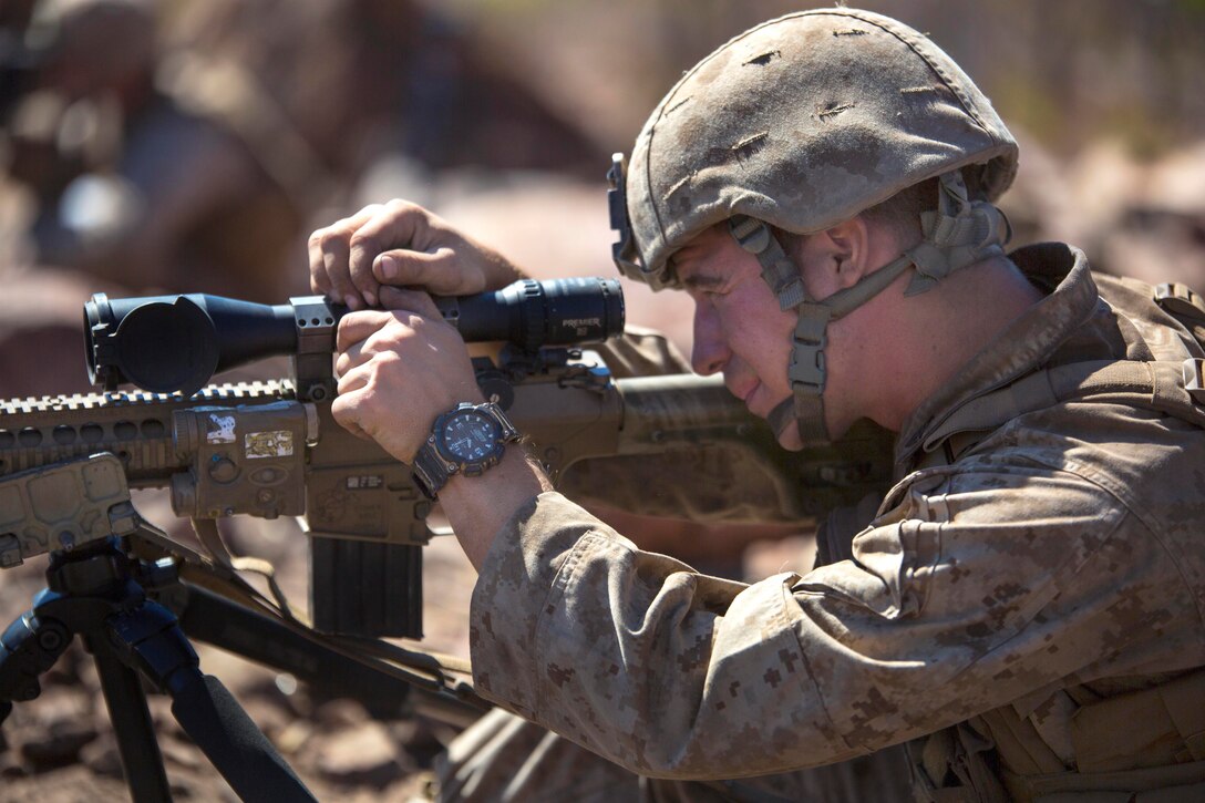 U.S. Marine Corps Sgt. Tyler J. Fox adjusts his M110 semi-automatic sniper system's wind and elevation knobs in preparation of an unknown distance qualification range during Exercise Koolendong 14 at Bradshaw Field Training Area, Australia, Aug. 18, 2014. Fox is a rifleman assigned to Scout Sniper Platoon, 1st Battalion, 5th Marine Regiment.