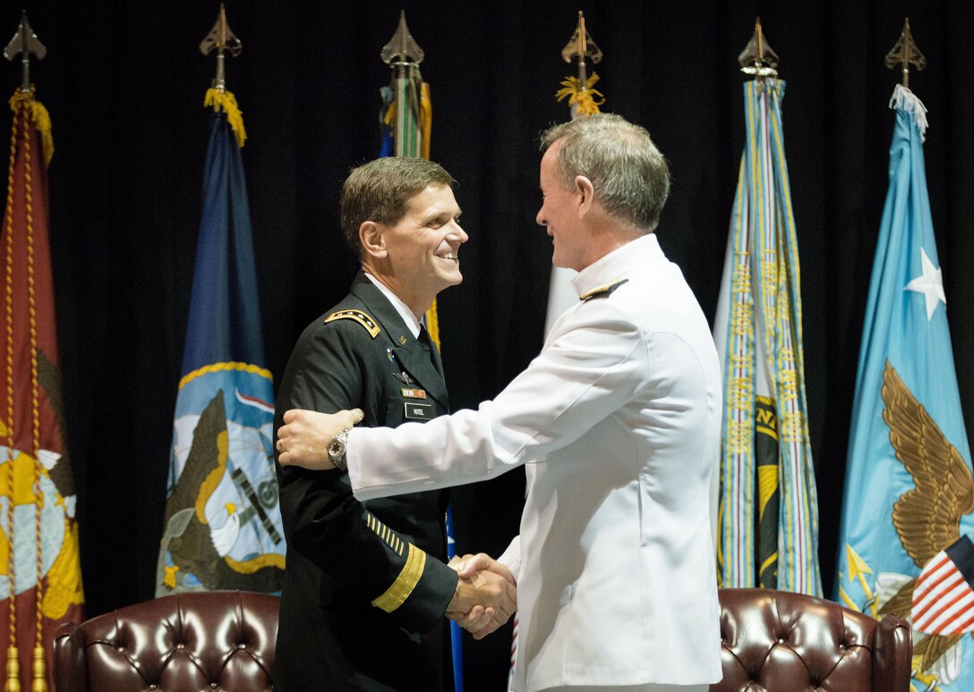 Navy Adm. William H. McRaven, right, embraces Army Gen. Joseph L. Votel III during the change-of-command ceremony for U.S. Special Operations Command in Tampa, Fla., Aug. 28, 2014. Votel assumed command from McRaven.