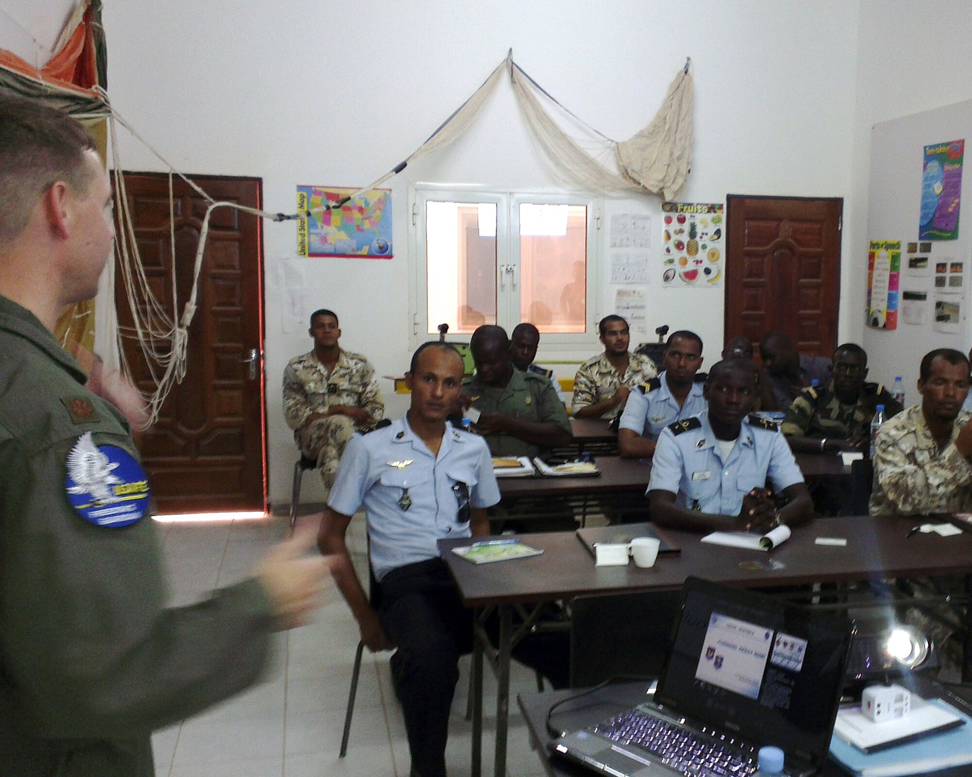U.S. Air Force Maj. Steven Payne, Intelligence, Surveillance, and Reconnaissance mission planning instructor from U.S. Air Forces in Europe and Air Forces Africa, discusses the Forward, Ready, Now, posture of USAFE-AFAFRICA at the beginning of his African Partnership Flight class on ISR mission planning at Atar Air Base, Atar, Mauritania, Aug. 31, 2014. APF creates a lasting sustainable partnership, enabling the six participating African nations to fight against terrorism now and in the future. (U.S. Air Force photo/Master Sgt. Brian Boisvert/Released)